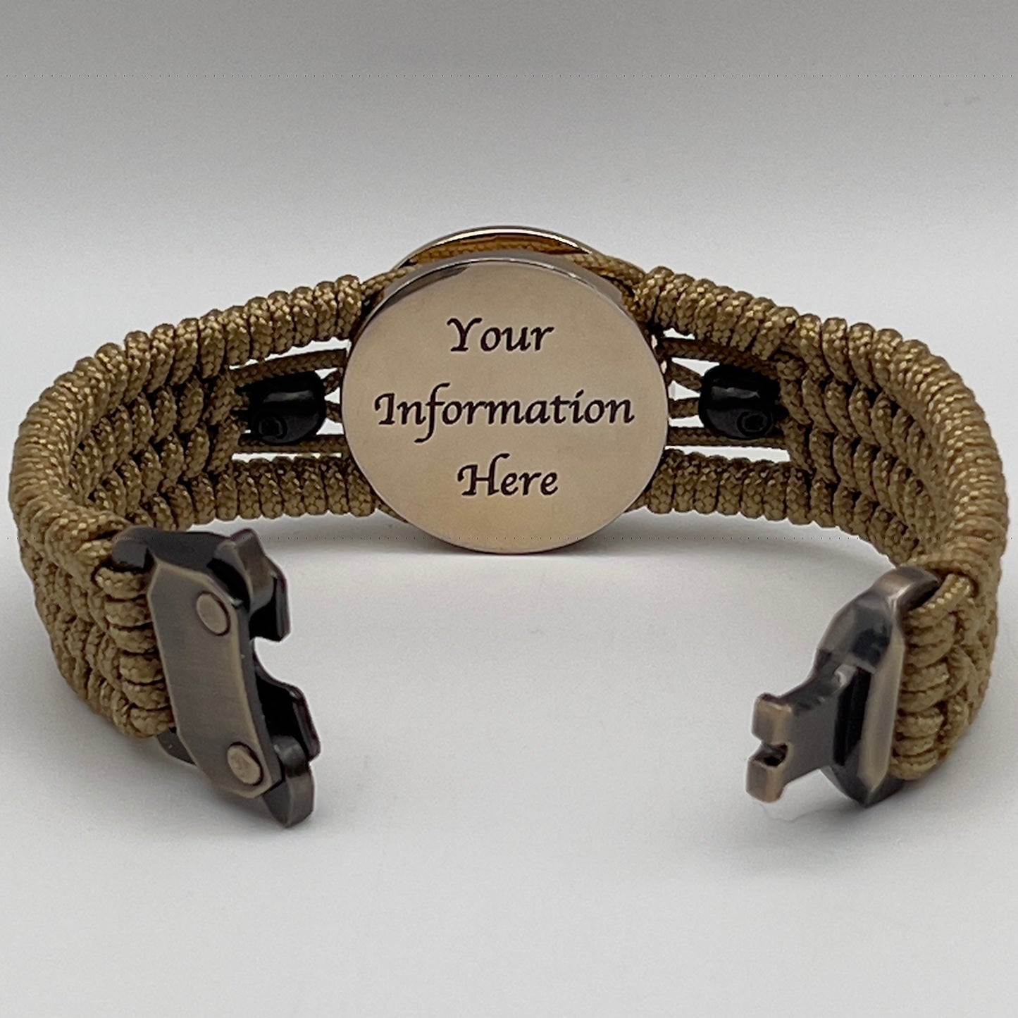 Thin, medium width, flexible and comfortable braided United States Marine Corps bracelet featuring a 24K gold plated USMC officer Eagle Globe and Anchor medallion, two black micro skulls, a gold Cobra style tactical buckle and woven with gold Type-1 paracord.