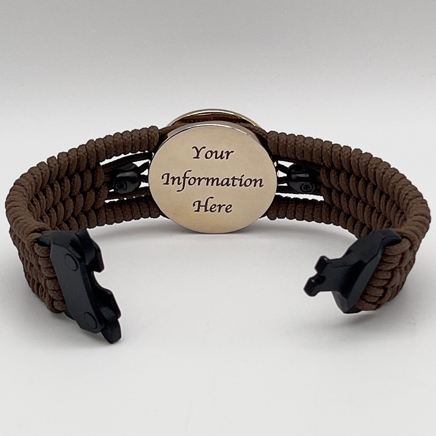 Thin, medium width, flexible and comfortable braided United States Marine Corps bracelet featuring a 24K gold plated USMC officer Eagle Globe and Anchor medallion, two black micro skulls, a black Cobra style tactical buckle and woven with Coyote Brown Type-1 paracord.