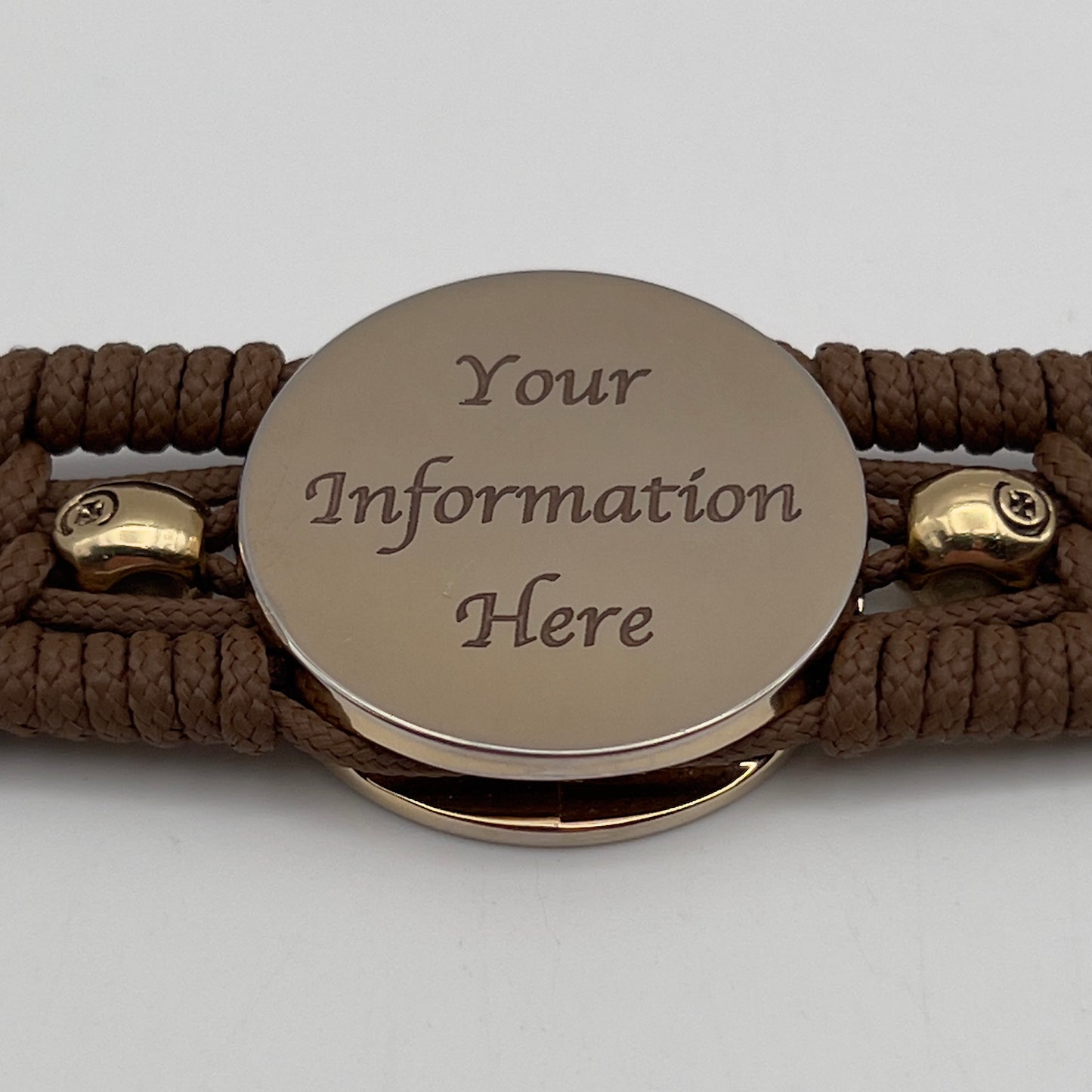 Thin, medium width, flexible and comfortable braided United States Marine Corps bracelet featuring a 24K gold plated USMC officer Eagle Globe and Anchor medallion, two gold plated skulls, a gold Cobra style tactical buckle and woven with Coyote Brown Type-1 paracord.
