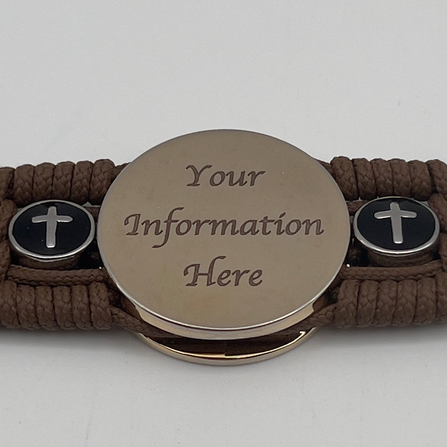 Thin, medium width, flexible and comfortable braided United States Marine Corps bracelet featuring a 24K gold plated USMC officer Eagle Globe and Anchor medallion, two Christian crosses, a black Cobra style tactical buckle and woven with Coyote Brown Type-1 paracord.