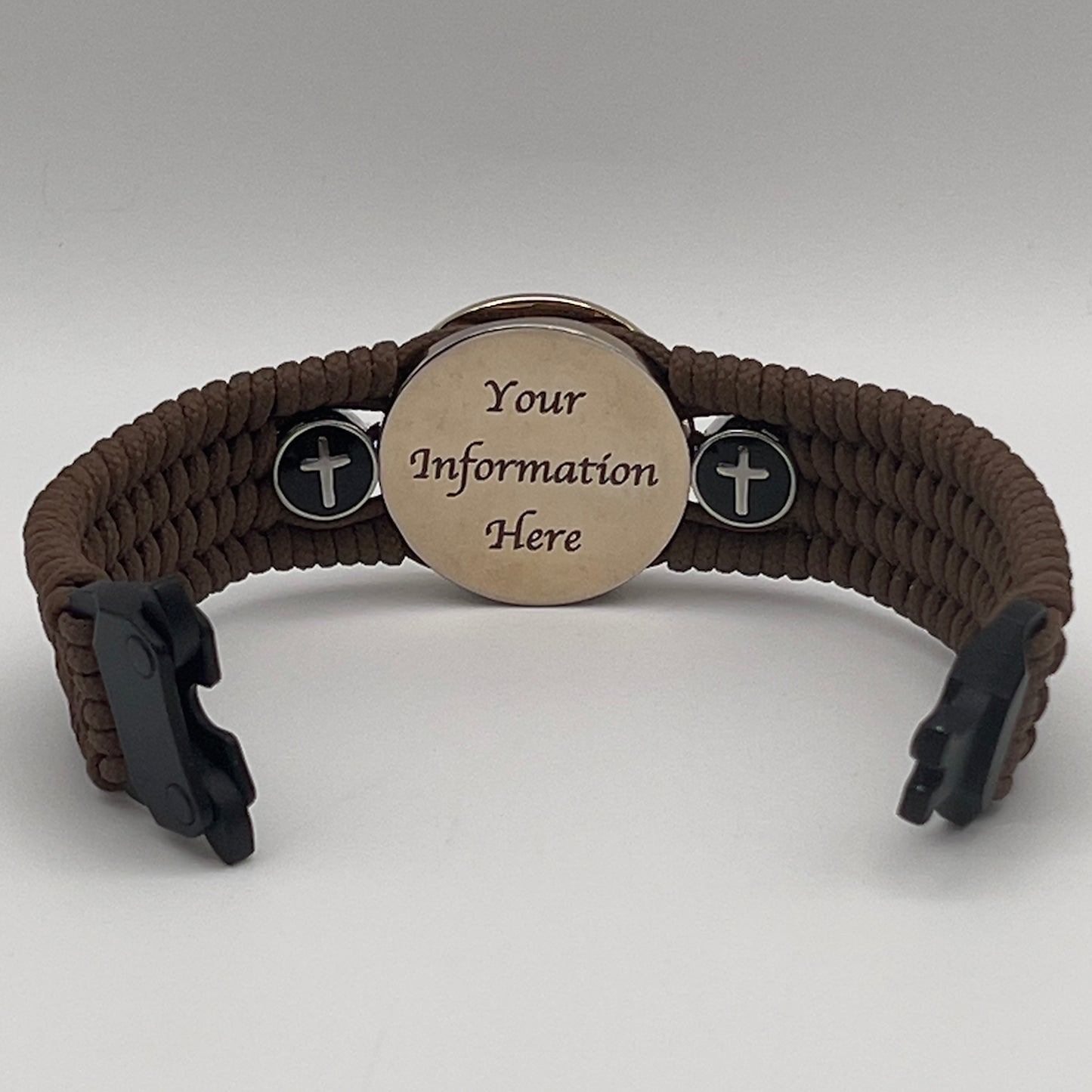 Thin, medium width, flexible and comfortable braided United States Marine Corps bracelet featuring a 24K gold plated USMC officer Eagle Globe and Anchor medallion, two Christian crosses, a black Cobra style tactical buckle and woven with Coyote Brown Type-1 paracord.