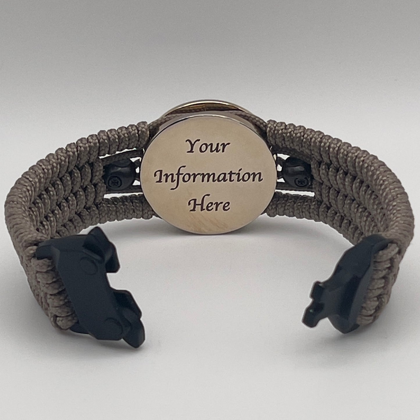 Thin, medium width, flexible and comfortable braided United States Marine Corps bracelet featuring a 24K gold plated USMC officer Eagle Globe and Anchor medallion, two black skulls, a black Cobra style tactical buckle and woven with tan Type-1 paracord.