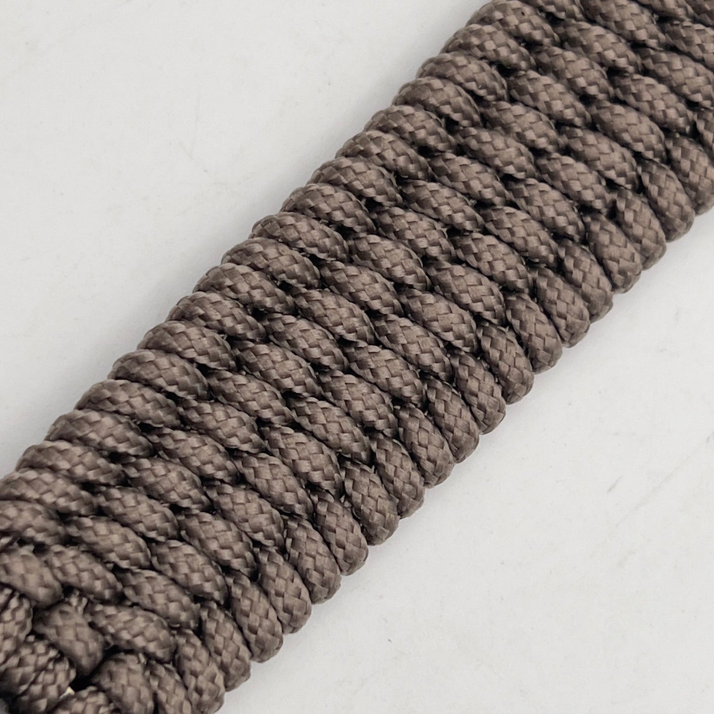 Thin, medium width, flexible and comfortable braided United States Marine Corps bracelet featuring a 24K gold plated USMC officer Eagle Globe and Anchor medallion, a gold Cobra style tactical buckle and woven with Tan Type-1 paracord.