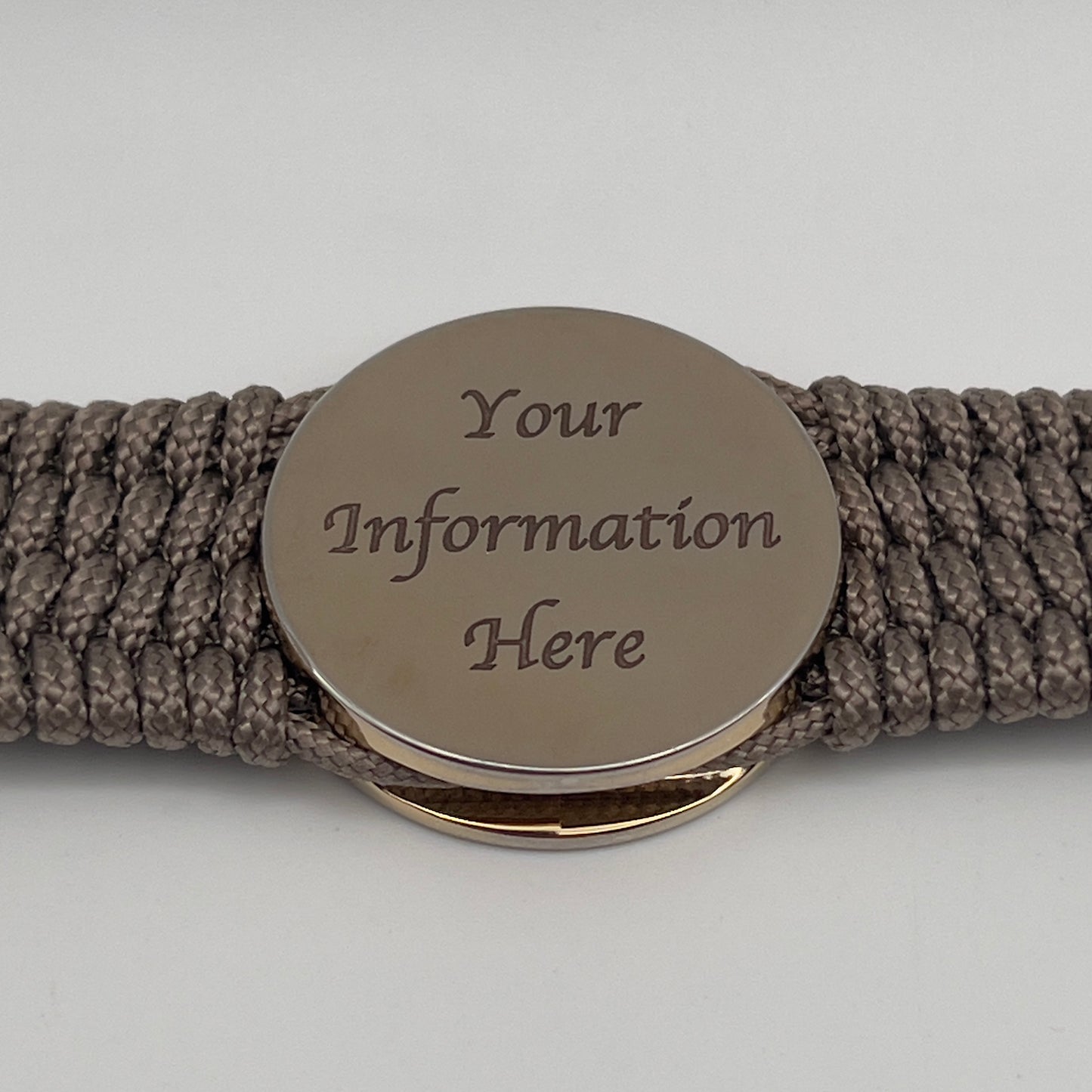 Thin, medium width, flexible and comfortable braided United States Marine Corps bracelet featuring a 24K gold plated USMC officer Eagle Globe and Anchor medallion, a gold Cobra style tactical buckle and woven with Tan Type-1 paracord.