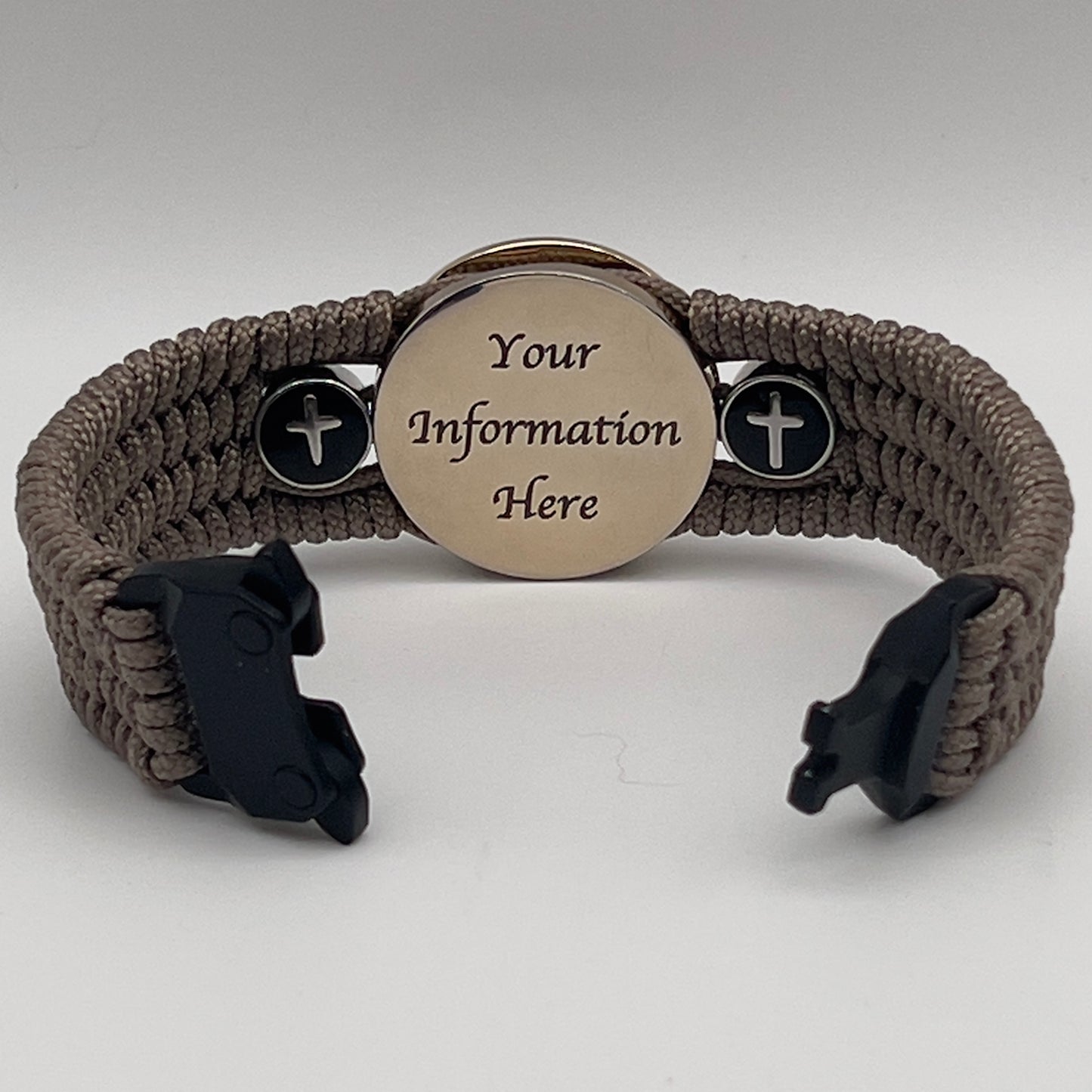 Thin, medium width, flexible and comfortable braided United States Marine Corps bracelet featuring a 24K gold plated USMC officer Eagle Globe and Anchor medallion, two Christian crosses, a black Cobra style tactical buckle and woven with Tan Type-1 paracord.