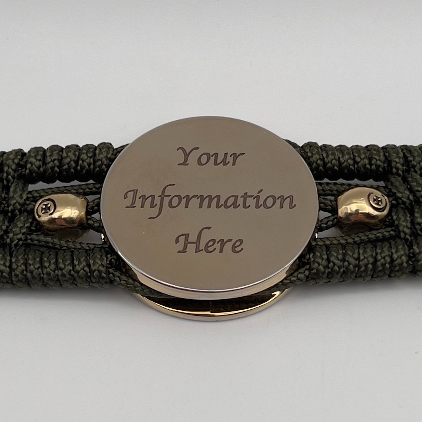 Thin, medium width, flexible and comfortable braided United States Marine Corps bracelet featuring a 24K gold plated USMC officer Eagle Globe and Anchor medallion, two gold plated skulls, a gold Cobra style tactical buckle and woven with Olive Drab Type-1 paracord.