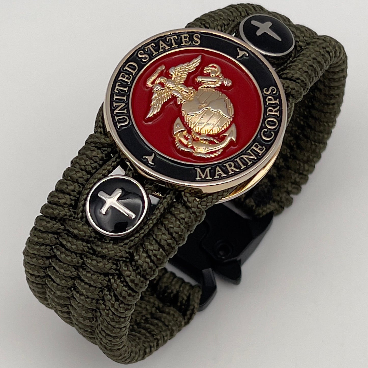 Thin, medium width, flexible and comfortable braided United States Marine Corps bracelet featuring a 24K gold plated USMC officer Eagle Globe and Anchor medallion, two Christian crosses, a black Cobra style tactical buckle and woven with Olive Drab Type-1 paracord.