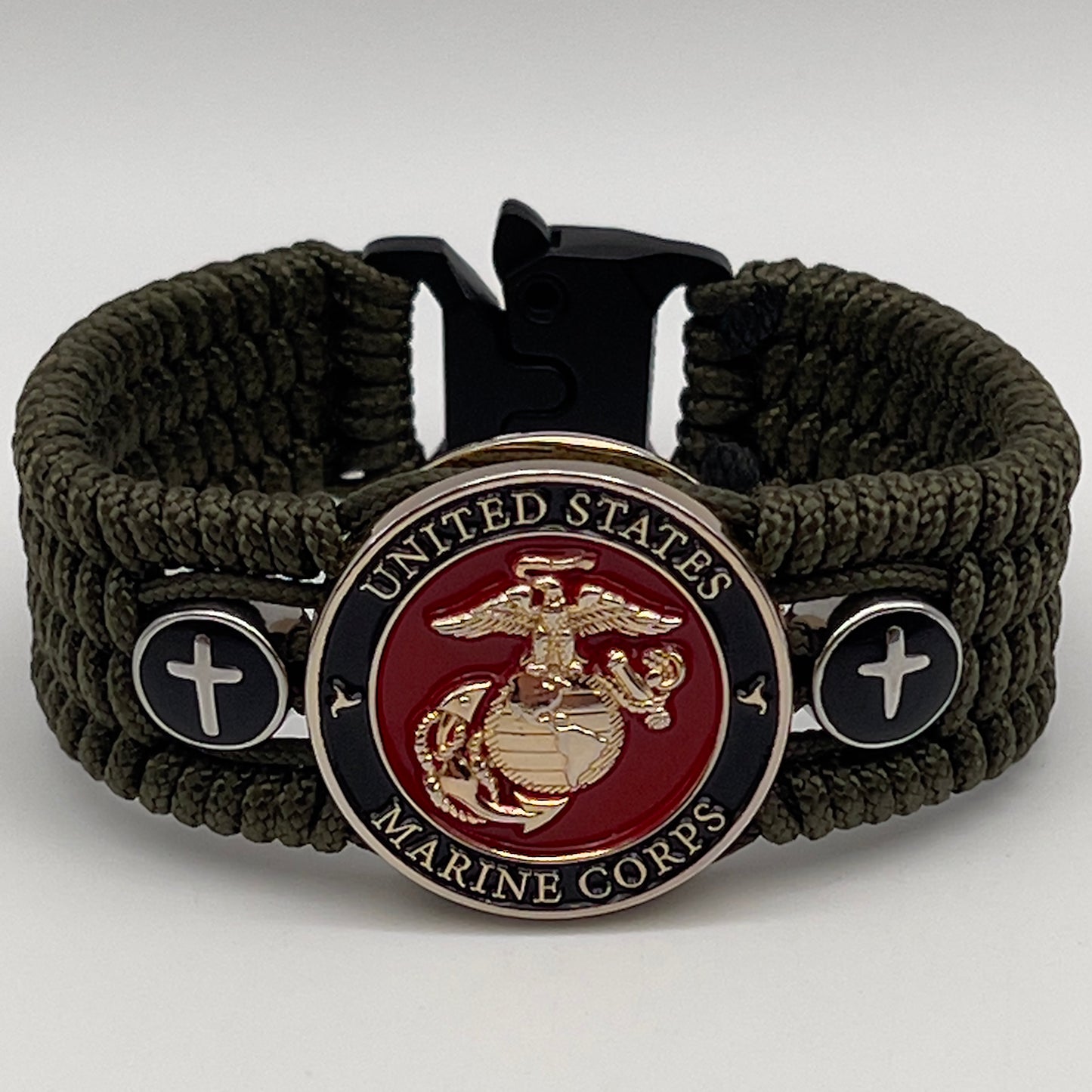 Thin, medium width, flexible and comfortable braided United States Marine Corps bracelet featuring a 24K gold plated USMC officer Eagle Globe and Anchor medallion, two Christian crosses, a black Cobra style tactical buckle and woven with Olive Drab Type-1 paracord.