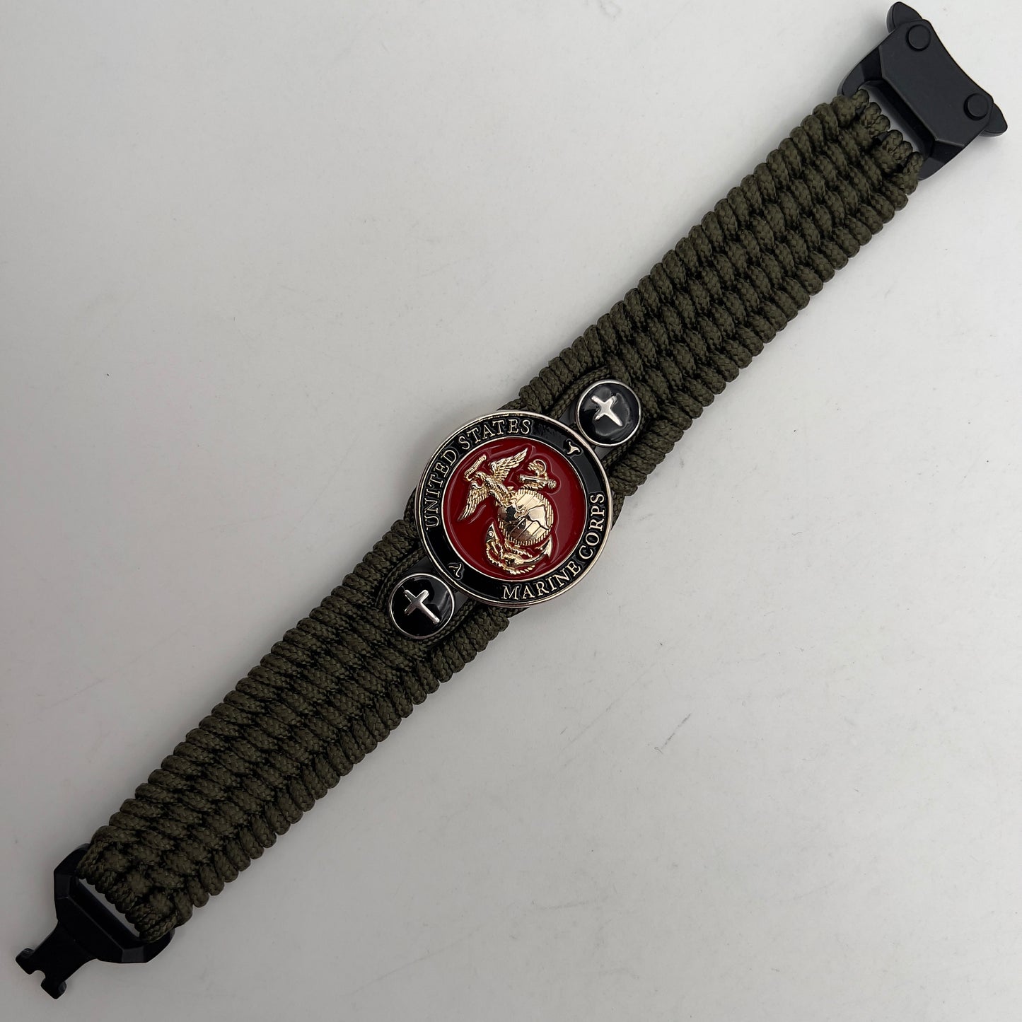 Thin, medium width, flexible and comfortable braided United States Marine Corps bracelet featuring a 24K gold plated USMC officer Eagle Globe and Anchor medallion, two Christian crosses, a black Cobra style tactical buckle and woven with Olive Drab Type-1 paracord.