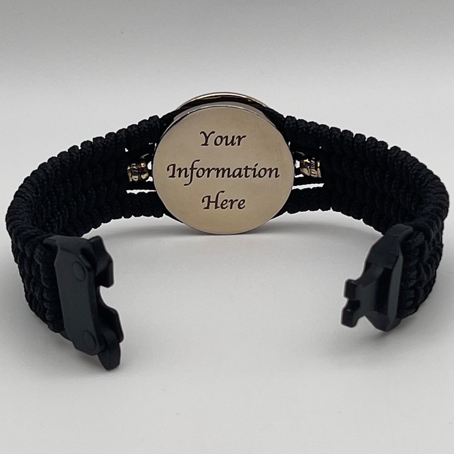 Thin, medium width, flexible and comfortable braided United States Marine Corps bracelet featuring a 24K gold plated USMC officer Eagle Globe and Anchor medallion, two brass Spartan helmets, a black Cobra style tactical buckle and woven with black Type-1 paracord.