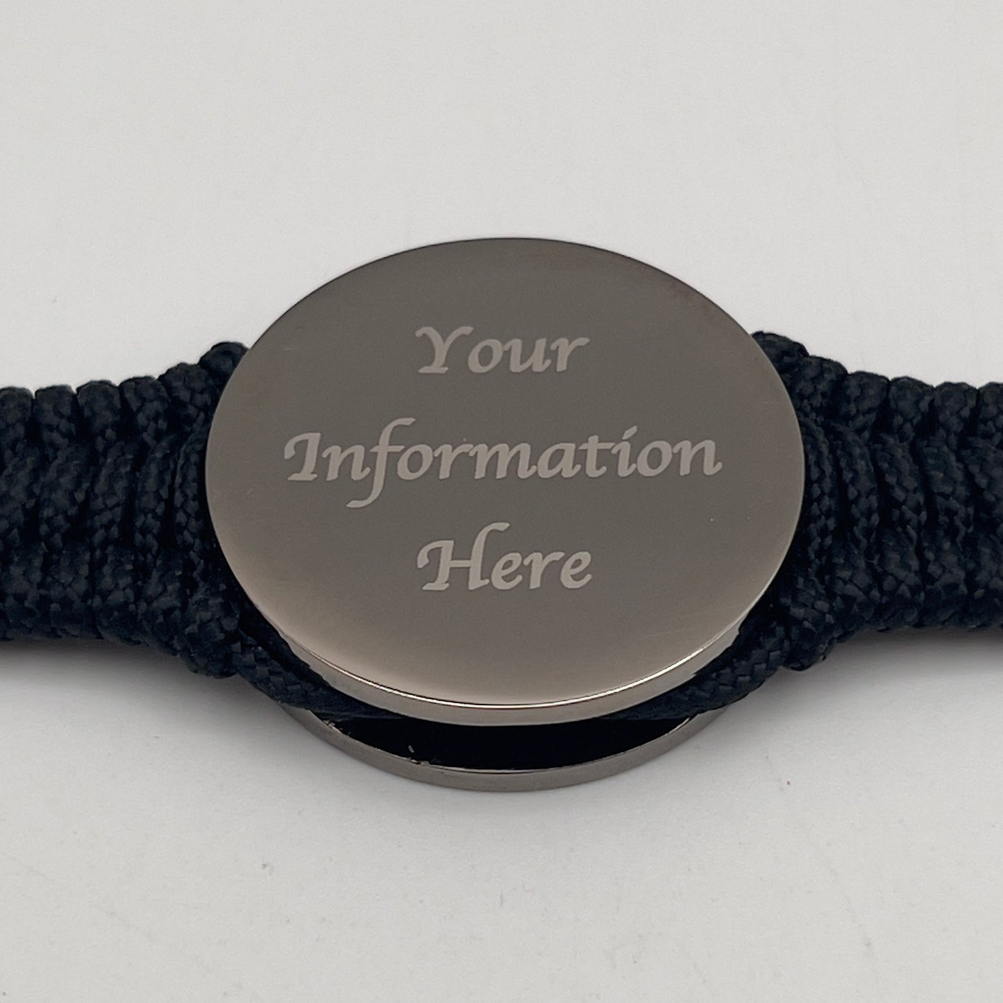 Thin, narrow, flexible and comfortable braided United States Marine Corps Recruit Depot Yellow Footprints bracelet featuring a black nickel plated UV enamel painted medallion replica of an actual set of USMC footprints, a black Cobra style tactical buckle and woven with black Type-1 paracord.