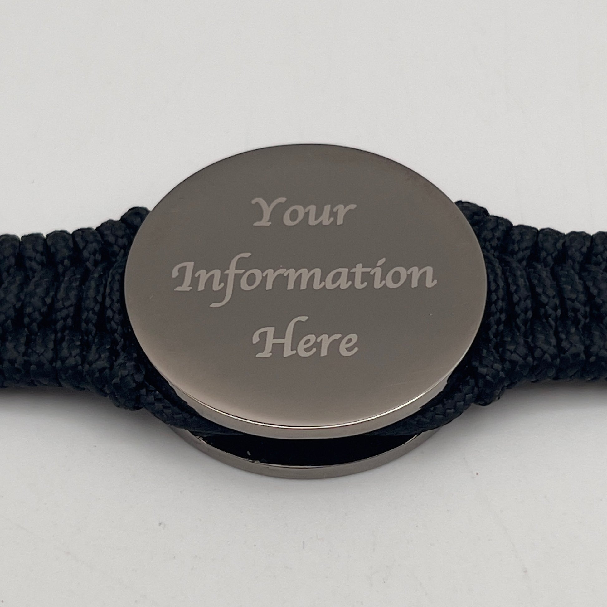 Thin, narrow, flexible and comfortable braided United States Marine Corps Recruit Depot Yellow Footprints bracelet featuring a black nickel plated UV enamel painted medallion replica of an actual set of USMC footprints, a black Cobra style tactical buckle and woven with black Type-1 paracord.