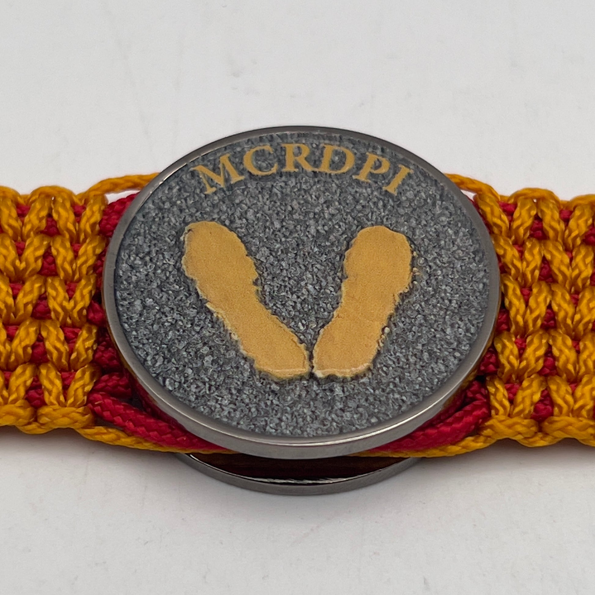 Thin, narrow, flexible and comfortable braided United States Marine Corps Recruit Depot Yellow Footprints bracelet featuring a black nickel plated UV enamel painted medallion replica of an actual set of USMC footprints, a black Cobra style tactical buckle and woven with Imperial Red type-1 paracord and Goldenrod micro cord.
