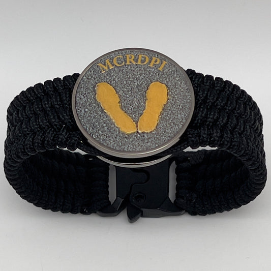 Thin, wide, flexible and comfortable braided United States Marine Corps Recruit Depot Yellow Footprints bracelet featuring a black nickel plated UV enamel painted medallion replica of an actual set of USMC footprints, a black Cobra style tactical buckle and woven with black Type-1 paracord.