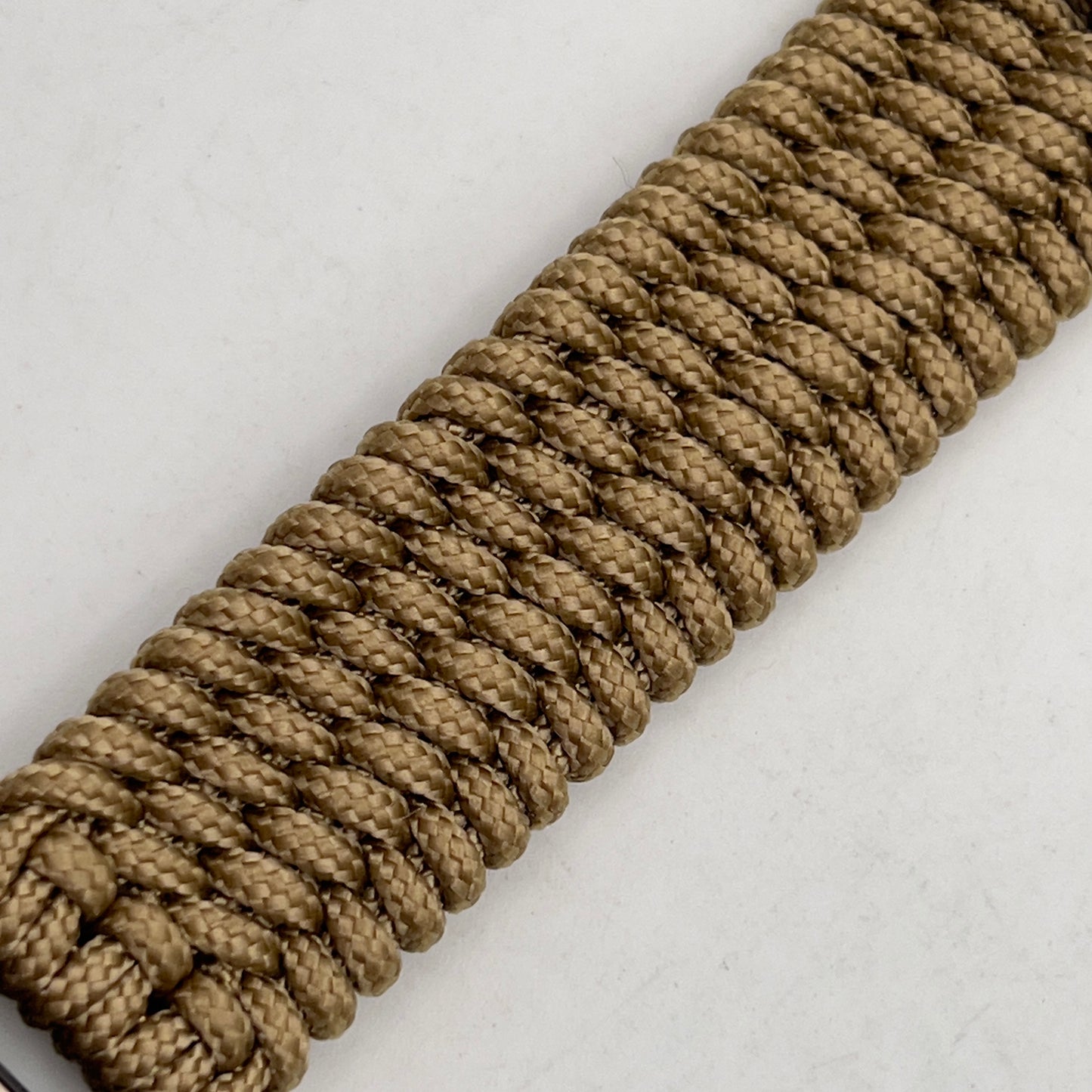 Thin, wide, flexible and comfortable braided United States Marine Corps Recruit Depot Yellow Footprints bracelet featuring a black nickel plated UV enamel painted medallion replica of an actual set of USMC footprints, a gold Cobra style tactical buckle and woven with gold Type-1 paracord.