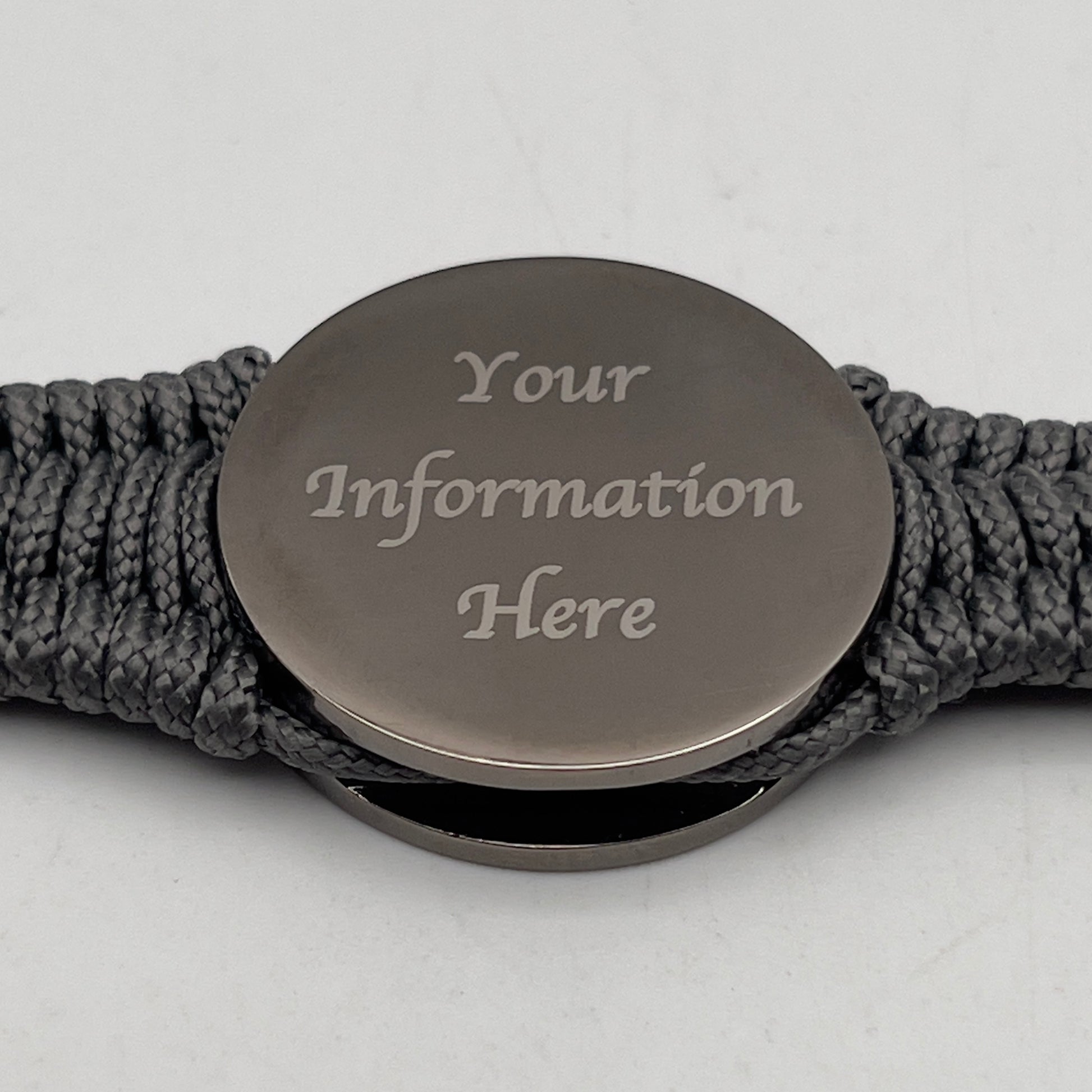 Thin, narrow, flexible and comfortable braided United States Marine Corps Recruit Depot Yellow Footprints bracelet featuring a black nickel plated UV enamel painted medallion replica of an actual set of USMC footprints, a silver Cobra style tactical buckle and woven with Charcoal Gray Type-1 paracord.