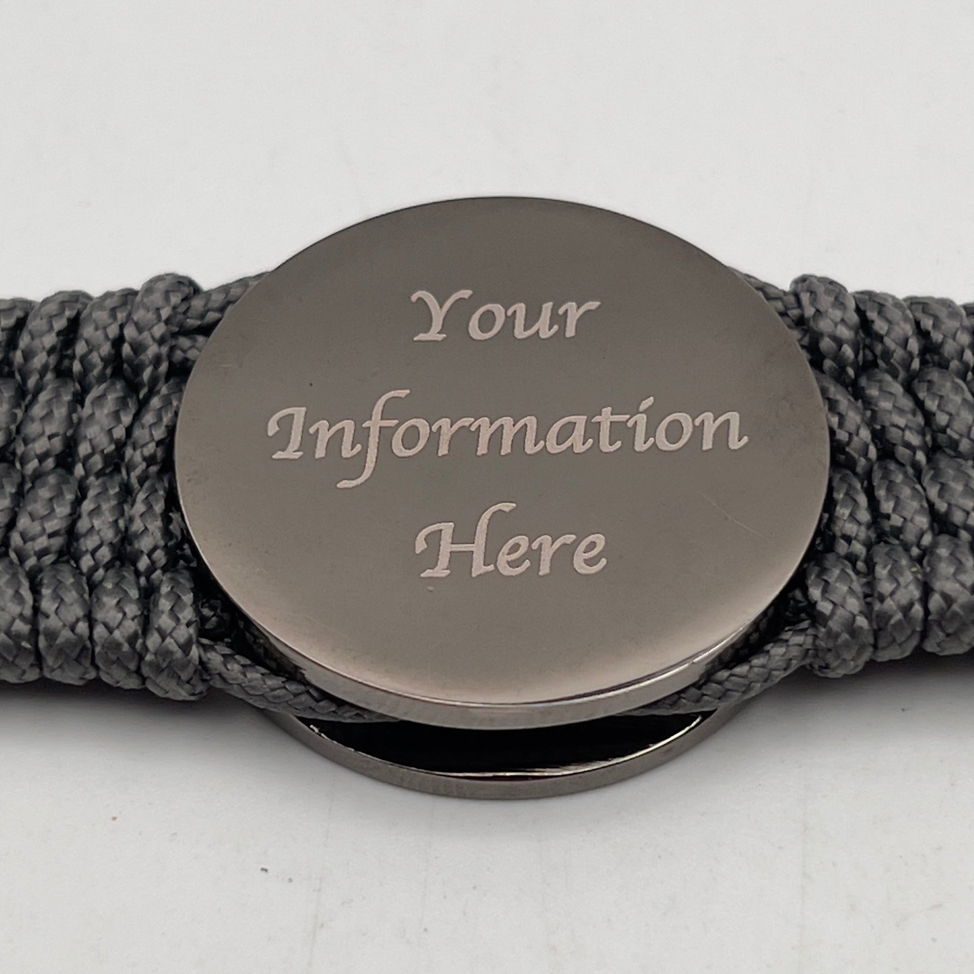 Thin, wide, flexible and comfortable braided United States Marine Corps Recruit Depot Yellow Footprints bracelet featuring a black nickel plated UV enamel painted medallion replica of an actual set of USMC footprints, a silver Cobra style tactical buckle and woven with Charcoal Gray Type-1 paracord.