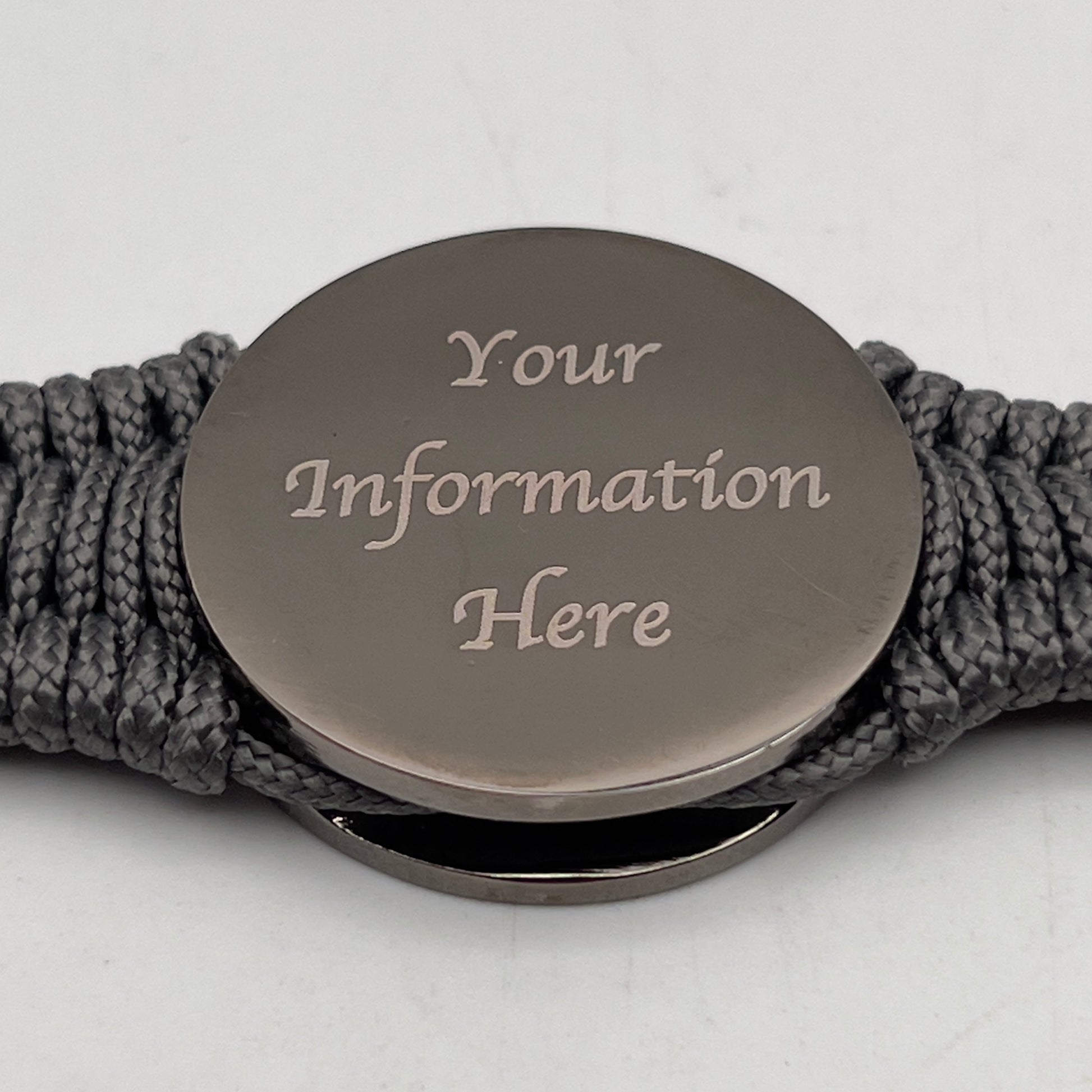 Thin, narrow, flexible and comfortable braided United States Marine Corps Recruit Depot Yellow Footprints bracelet featuring a black nickel plated UV enamel painted medallion replica of an actual set of USMC footprints, a silver Cobra style tactical buckle and woven with Charcoal Gray Type-1 paracord.