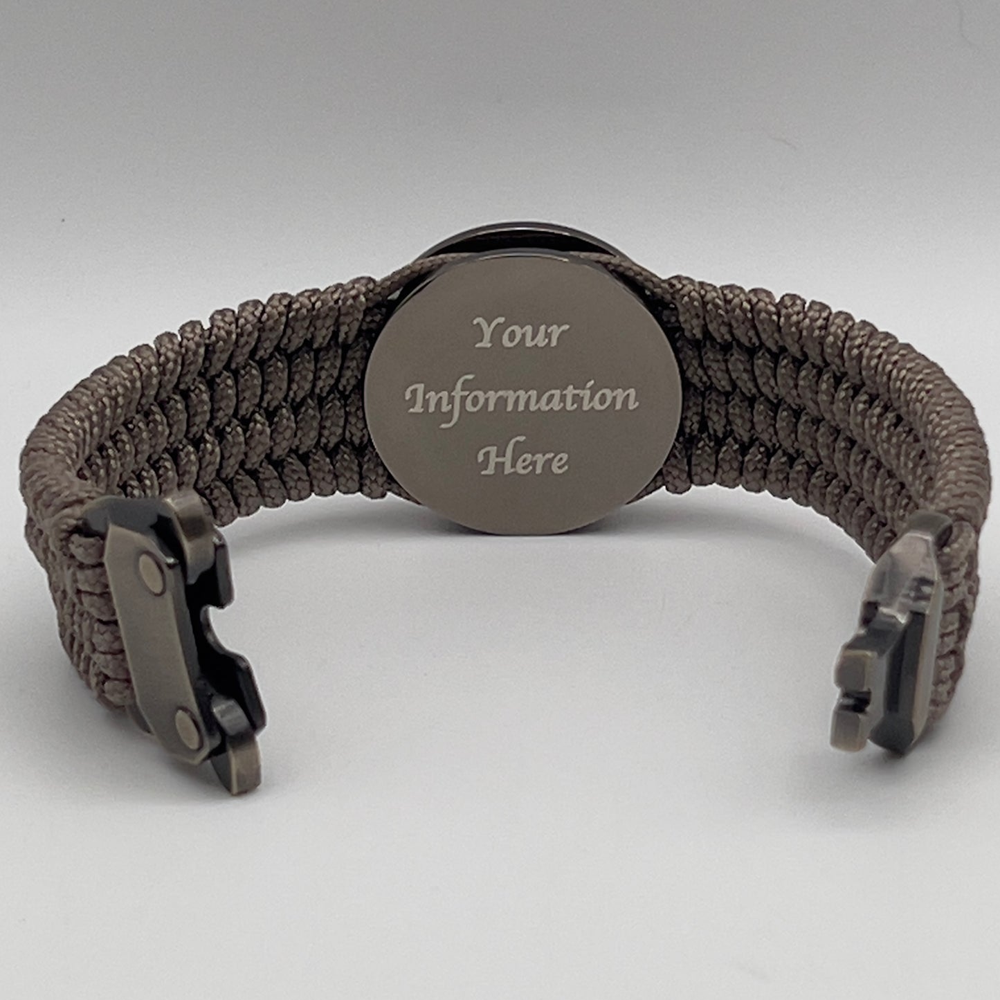 Thin, wide, flexible and comfortable braided United States Marine Corps Recruit Depot Yellow Footprints bracelet featuring a black nickel plated UV enamel painted medallion replica of an actual set of USMC recruit depot footprints, a gold Cobra style tactical buckle and woven with tan Type-1 paracord.