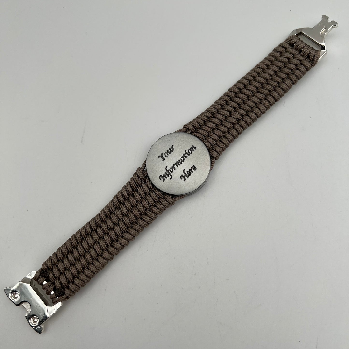 Thin, wide, flexible and comfortable braided United States Marine Corps Iwo Jima bracelet featuring an antique silver plated UV painted Iwo Jima flag raising medallion, a silver Cobra style tactical buckle and woven with tan Type-1 paracord.