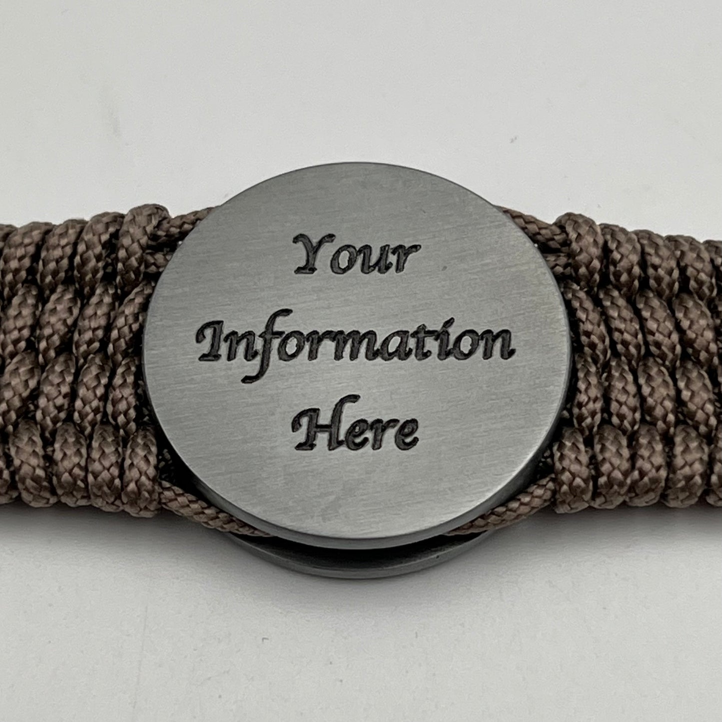 Thin, wide, flexible and comfortable braided United States Marine Corps Iwo Jima bracelet featuring an antique silver plated UV painted Iwo Jima flag raising medallion, a silver Cobra style tactical buckle and woven with tan Type-1 paracord.