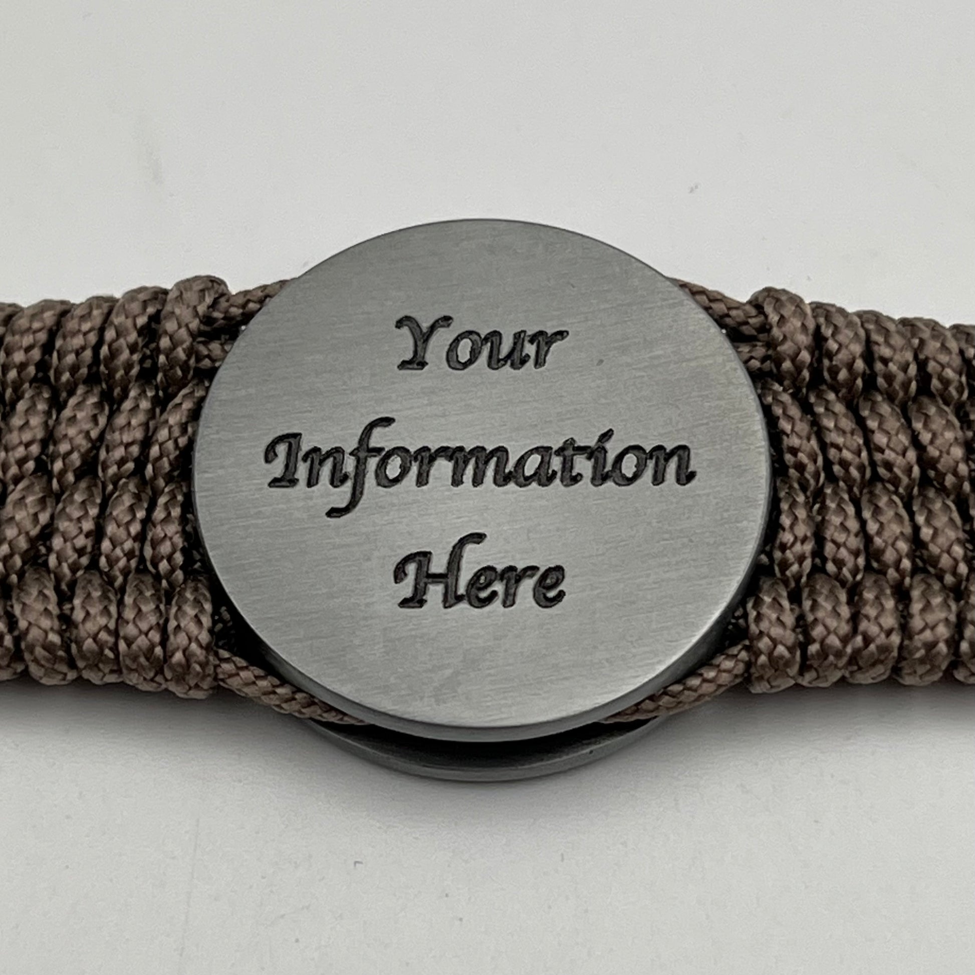 Thin, wide, flexible and comfortable braided United States Marine Corps Iwo Jima bracelet featuring an antique silver plated UV painted Iwo Jima flag raising medallion, a silver Cobra style tactical buckle and woven with tan Type-1 paracord.