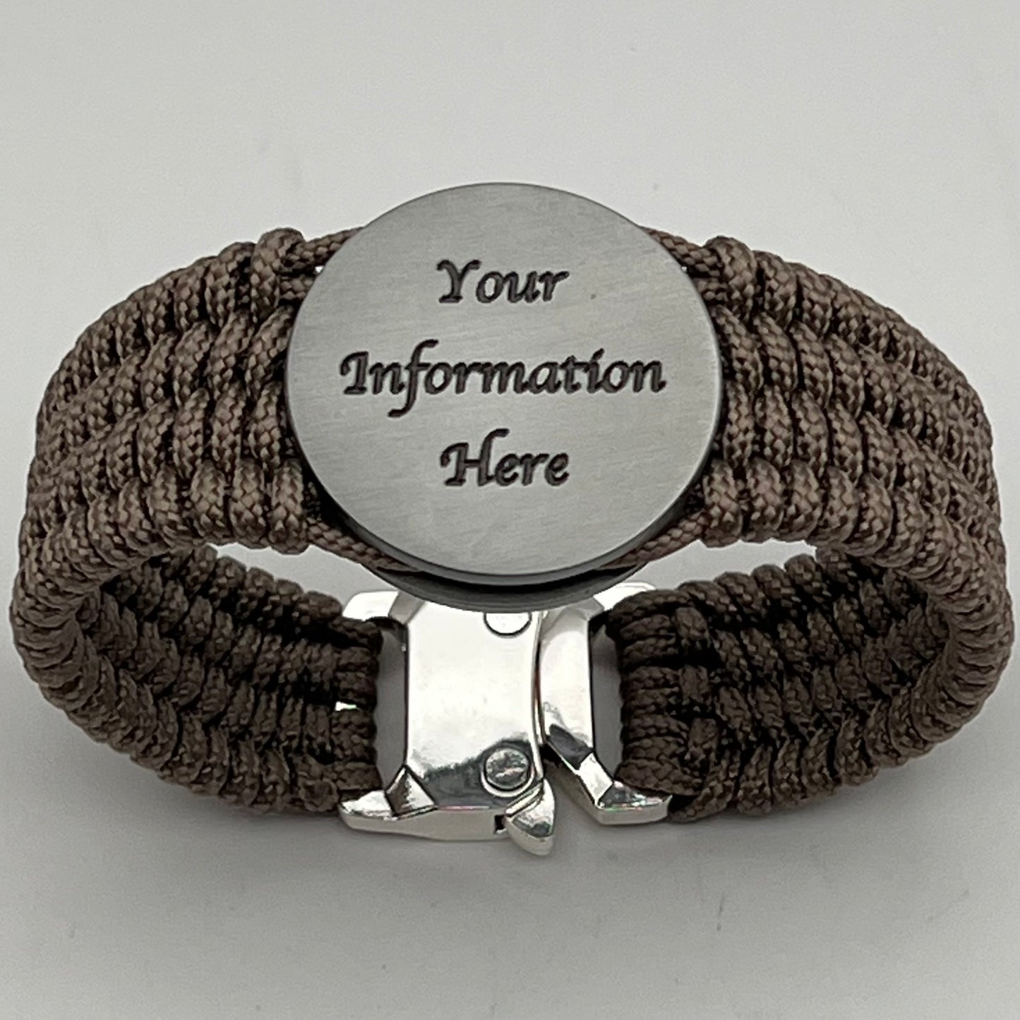 Thin, wide, flexible and comfortable braided United States Marine Corps Iwo Jima bracelet featuring an antique silver plated UV painted Iwo Jima flag raising medallion, a silver Cobra style tactical buckle and woven with tan Type-1 paracord.