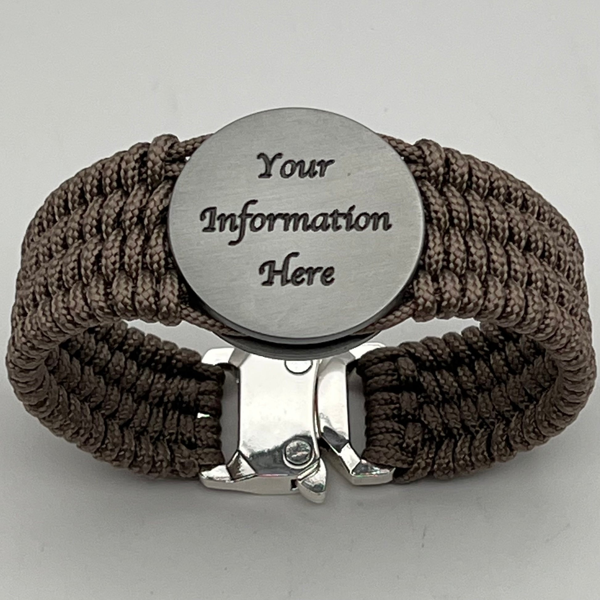 Thin, wide, flexible and comfortable braided United States Marine Corps Iwo Jima bracelet featuring an antique silver plated UV painted Iwo Jima flag raising medallion, a silver Cobra style tactical buckle and woven with tan Type-1 paracord.