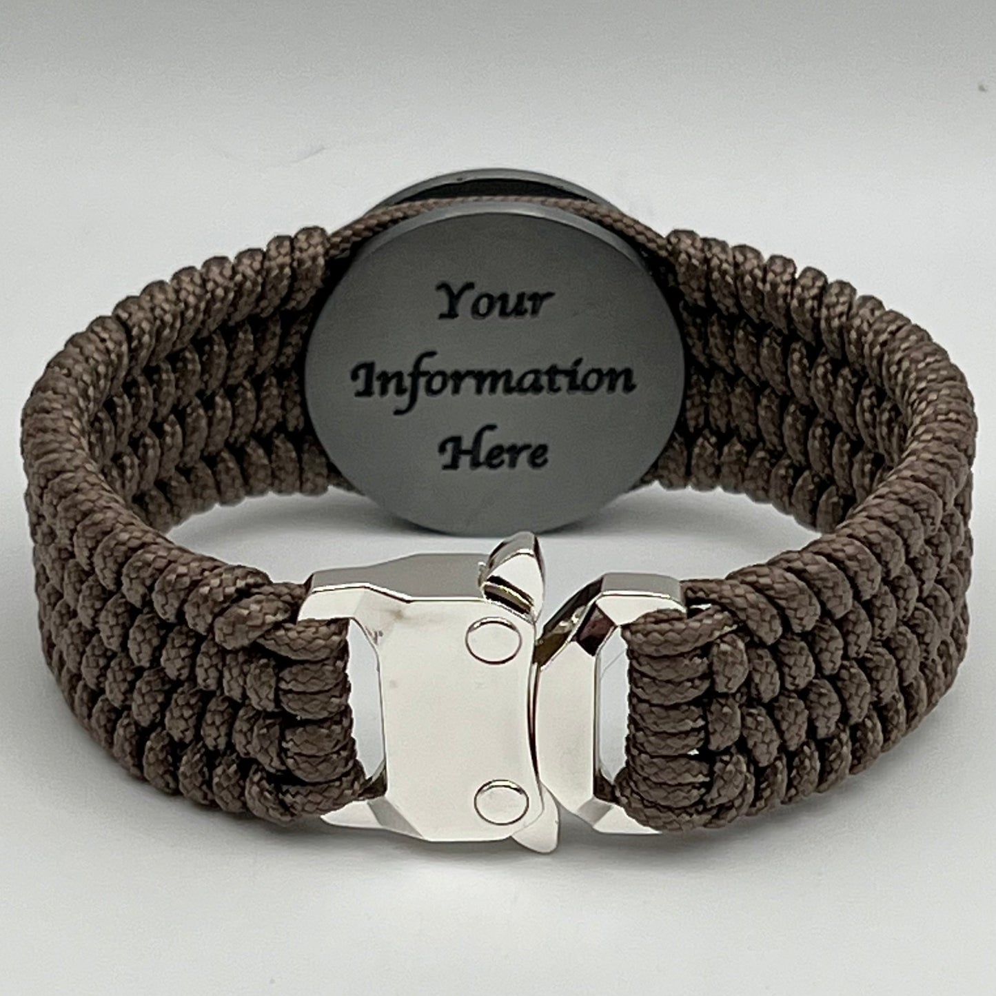 Thin, wide, flexible and comfortable braided United States Marine Corps Iwo Jima bracelet featuring an antique silver plated UV painted Iwo Jima flag raising medallion, a silver Cobra style tactical buckle and woven with tan Type-1 paracord.