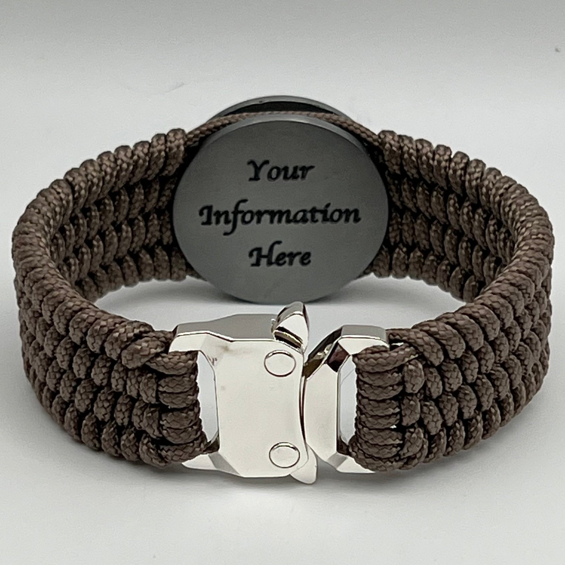 Thin, wide, flexible and comfortable braided United States Marine Corps Iwo Jima bracelet featuring an antique silver plated UV painted Iwo Jima flag raising medallion, a silver Cobra style tactical buckle and woven with tan Type-1 paracord.
