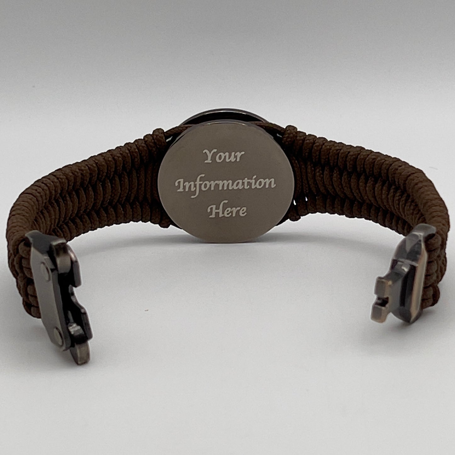 Thin, narrow, flexible and comfortable braided United States Marine Corps Recruit Depot Yellow Footprints bracelet featuring a black nickel plated UV enamel painted medallion replica of an actual set of USMC recruit depot footprints, a gold Cobra style tactical buckle and woven with Coyote Brown type-1 paracord.