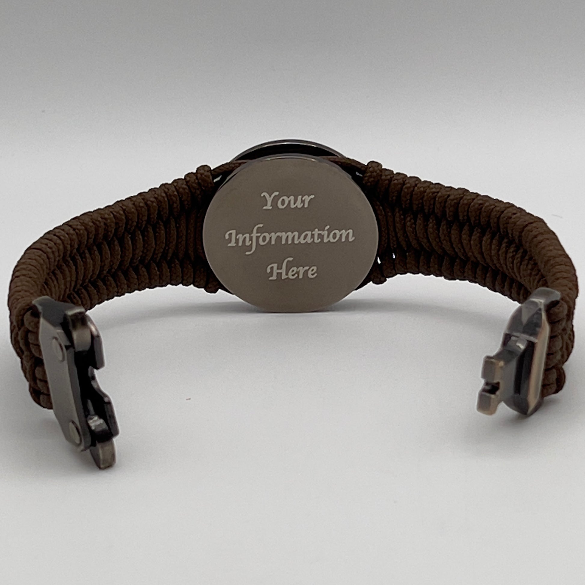 Thin, narrow, flexible and comfortable braided United States Marine Corps Recruit Depot Yellow Footprints bracelet featuring a black nickel plated UV enamel painted medallion replica of an actual set of USMC recruit depot footprints, a gold Cobra style tactical buckle and woven with Coyote Brown type-1 paracord.
