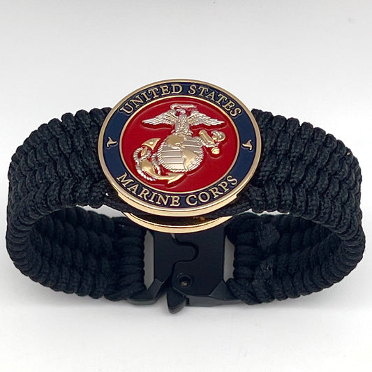 Thin, wide, flexible and comfortable braided United States Marine Corps bracelet featuring a 24K gold and silver plated USMC Eagle Globe and Anchor medallion, a black Cobra style tactical buckle and woven with black type-1 paracord.