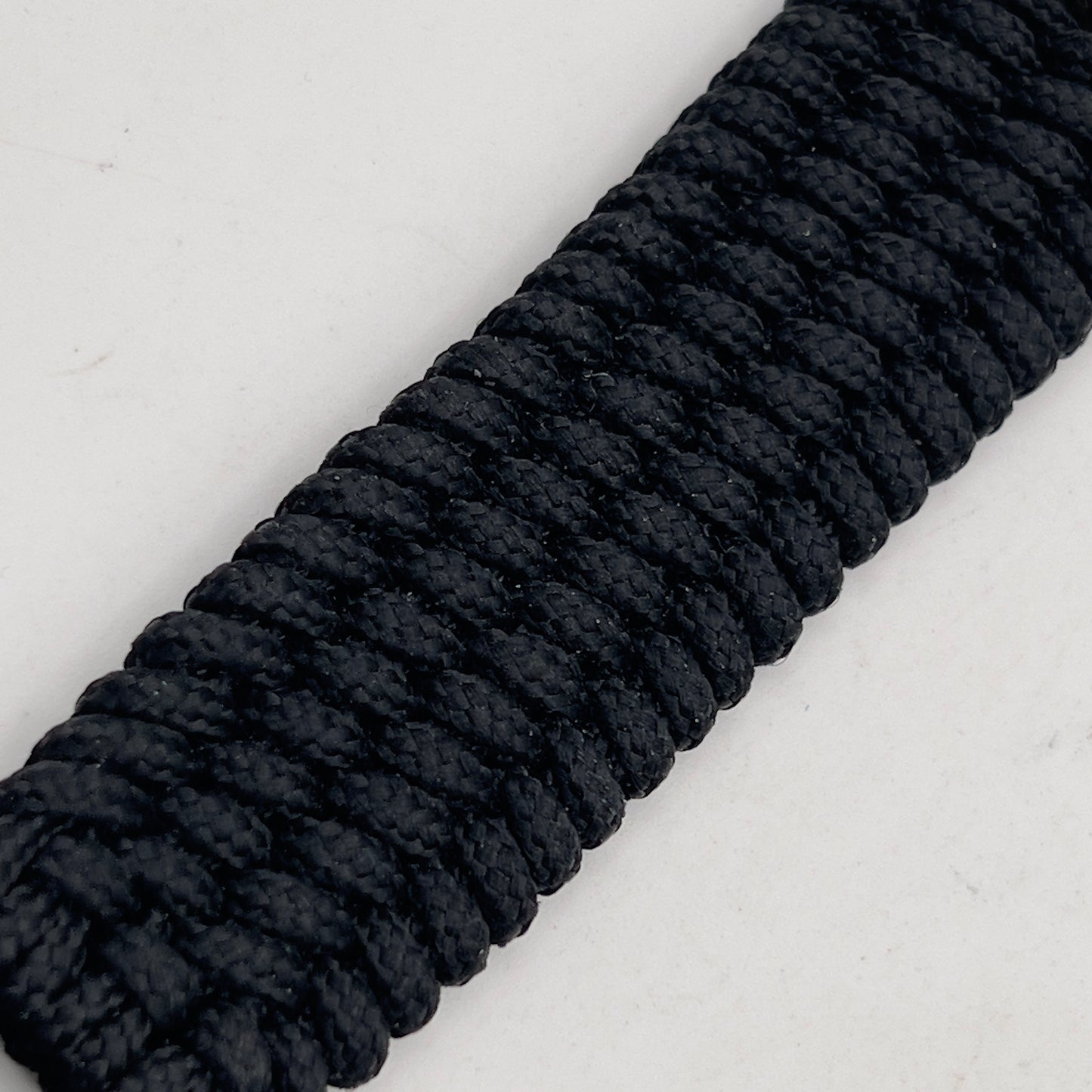 Thin, wide, flexible and comfortable braided United States Marine Corps bracelet featuring a 24K gold and silver plated USMC Eagle Globe and Anchor medallion, a black Cobra style tactical buckle and woven with black type-1 paracord.