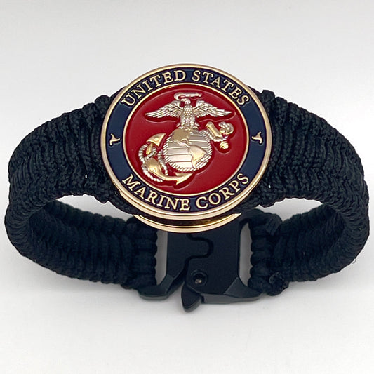 Thin, narrow, flexible and comfortable braided United States Marine Corps bracelet featuring a 24K gold and silver plated USMC Eagle Globe and Anchor medallion, a black Cobra style tactical buckle and woven with black type-1 paracord.