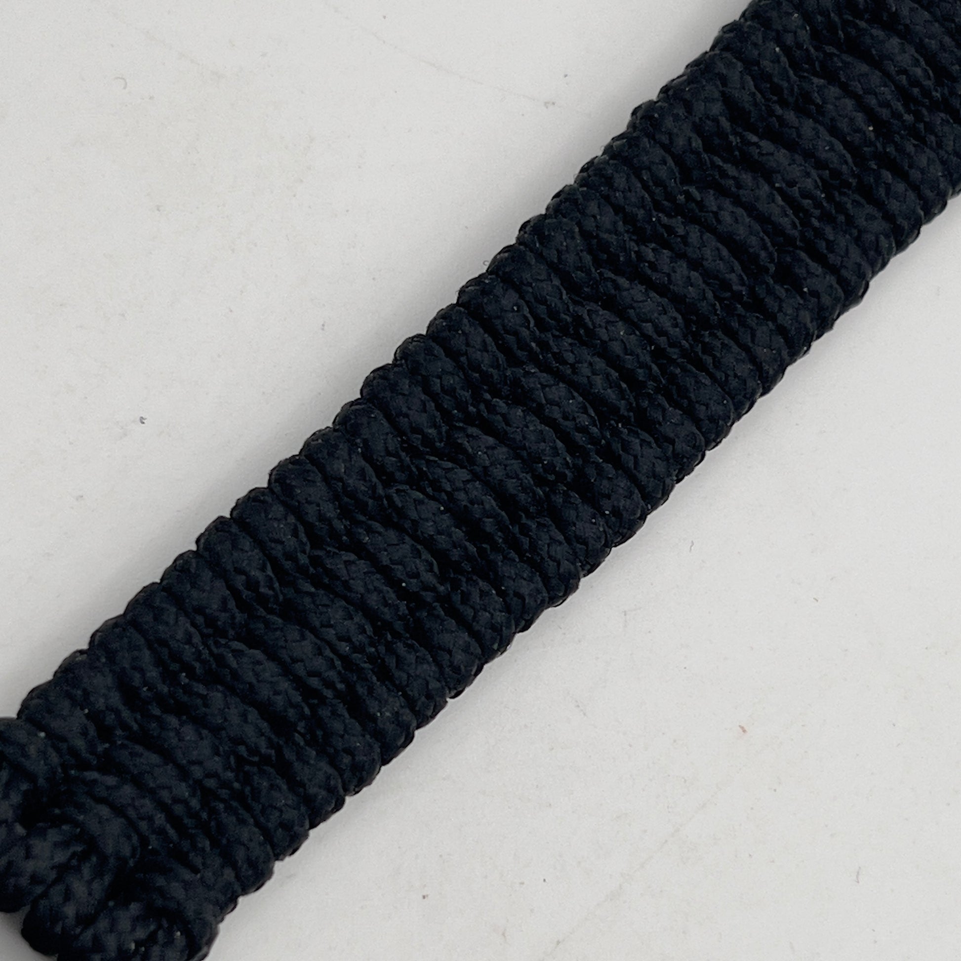 Thin, narrow, flexible and comfortable braided United States Marine Corps bracelet featuring a 24K gold and silver plated USMC Eagle Globe and Anchor medallion, a black Cobra style tactical buckle and woven with black type-1 paracord.