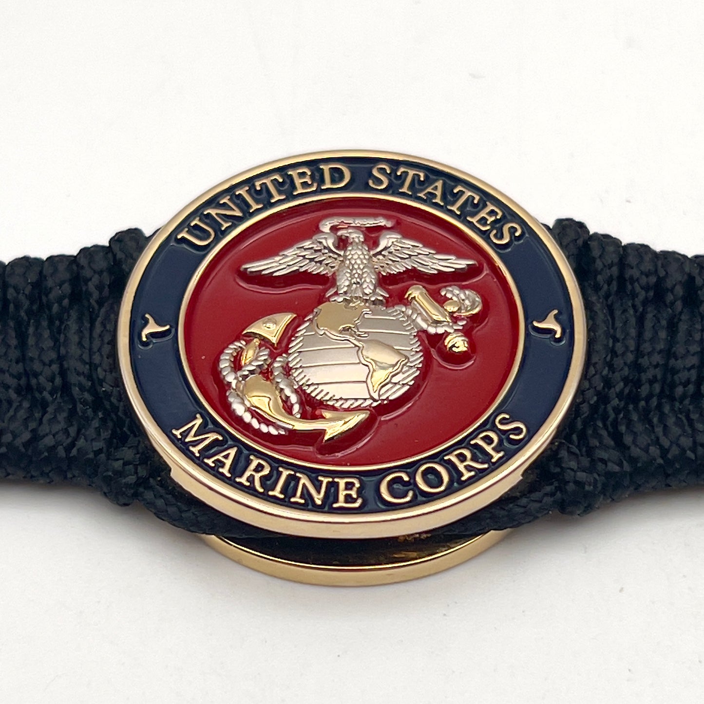 Thin, narrow, flexible and comfortable braided United States Marine Corps bracelet featuring a 24K gold and silver plated USMC Eagle Globe and Anchor medallion, a black Cobra style tactical buckle and woven with black type-1 paracord.