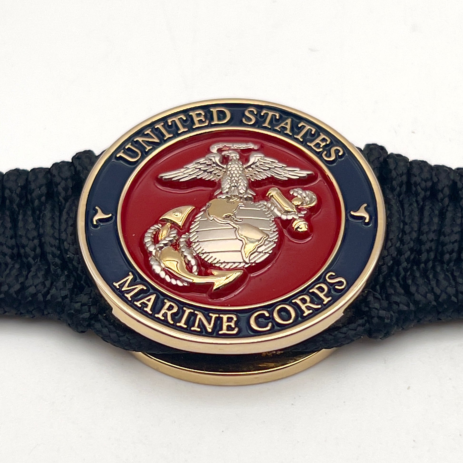 Thin, narrow, flexible and comfortable braided United States Marine Corps bracelet featuring a 24K gold and silver plated USMC Eagle Globe and Anchor medallion, a black Cobra style tactical buckle and woven with black type-1 paracord.