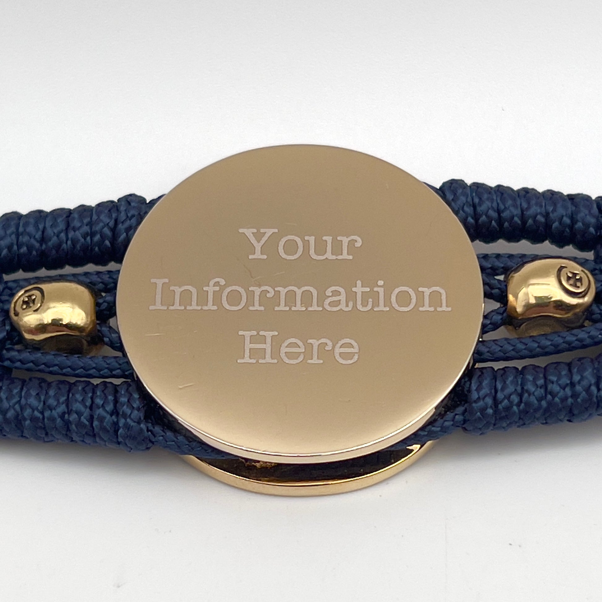 Thin, medium width, flexible and comfortable braided United States Marine Corps bracelet featuring a 24K gold and silver plated USMC officer Eagle Globe and Anchor medallion, two gold micro skulls, a gold Cobra style tactical buckle and woven with Navy blue type-1 paracord.