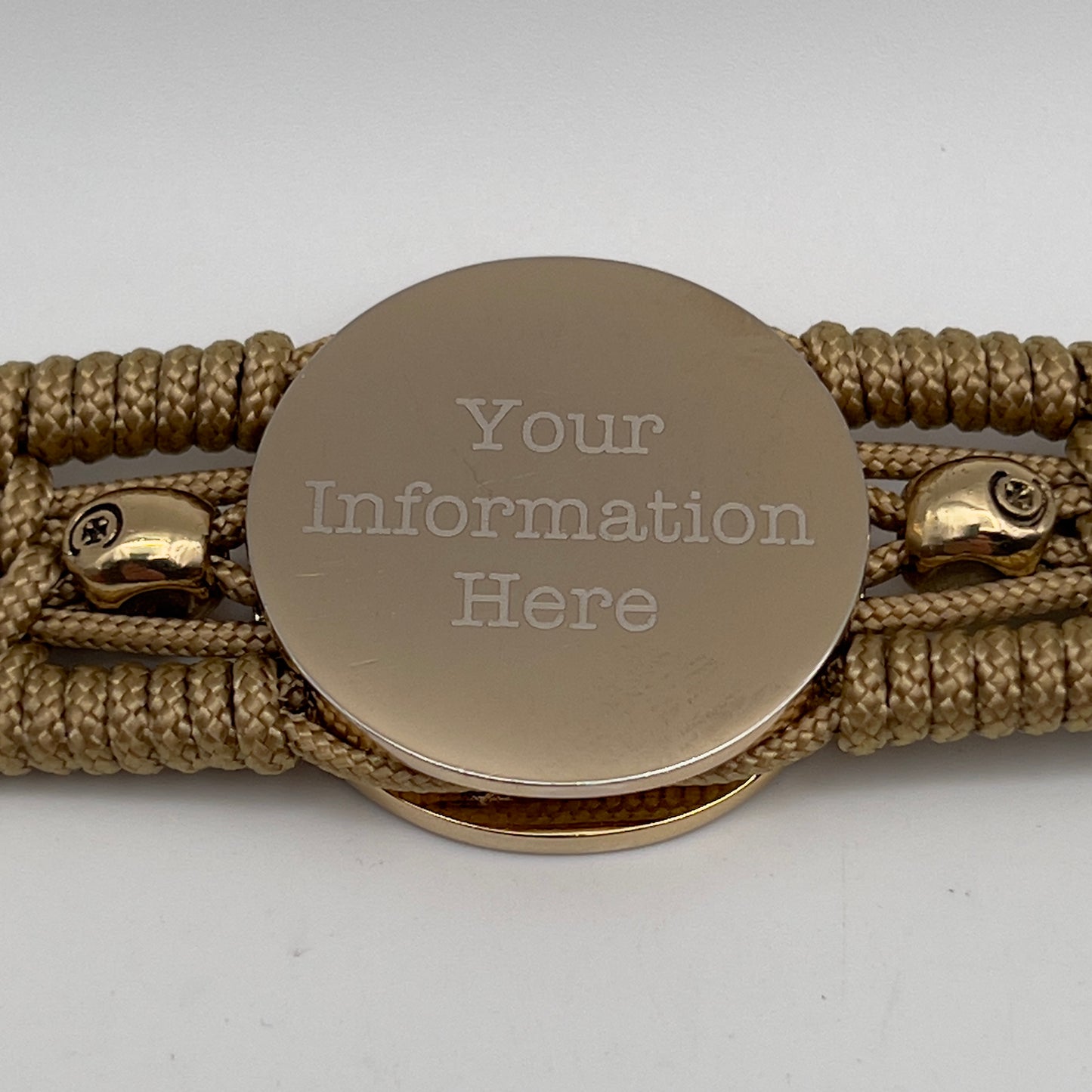 Thin, medium width, flexible and comfortable braided United States Marine Corps bracelet featuring a 24K gold and silver plated USMC officer Eagle Globe and Anchor medallion, two gold micro skulls, a gold Cobra style tactical buckle and woven with gold type-1 paracord.