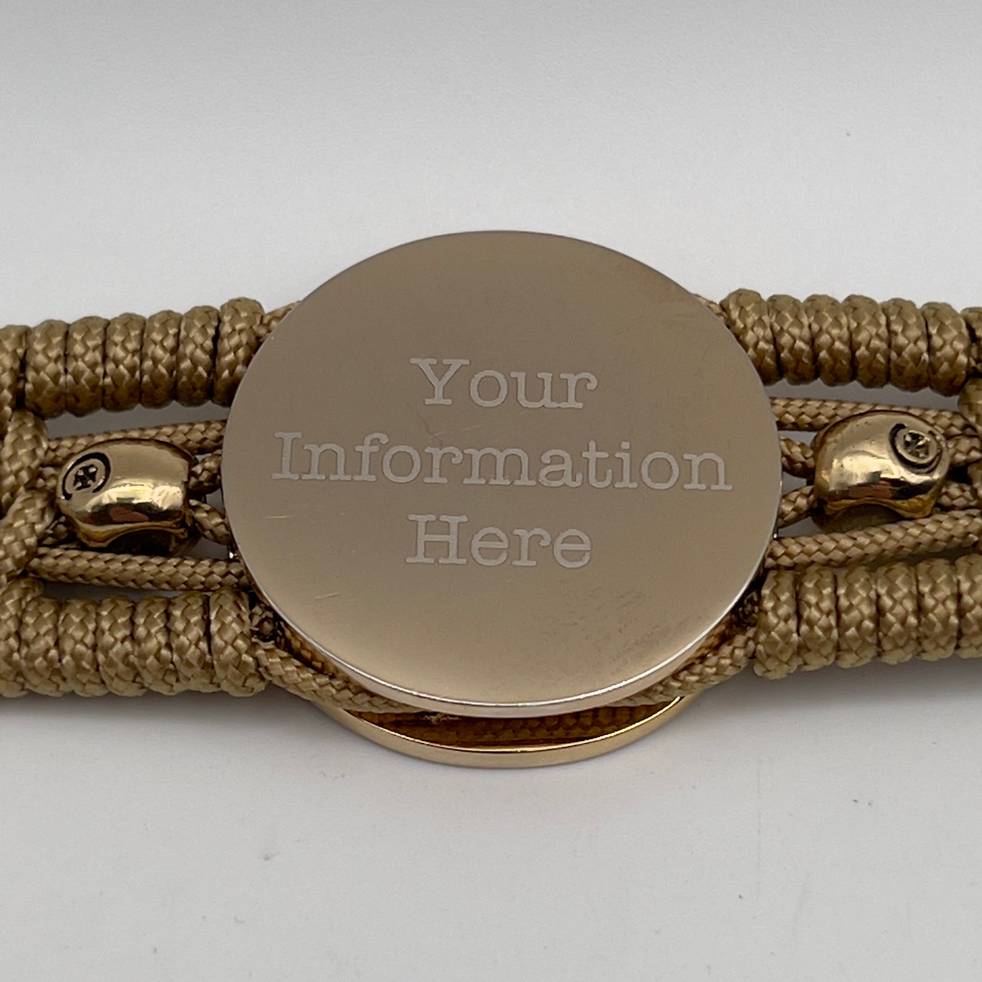 Thin, medium width, flexible and comfortable braided United States Marine Corps bracelet featuring a 24K gold and silver plated USMC officer Eagle Globe and Anchor medallion, two gold micro skulls, a gold Cobra style tactical buckle and woven with gold type-1 paracord.