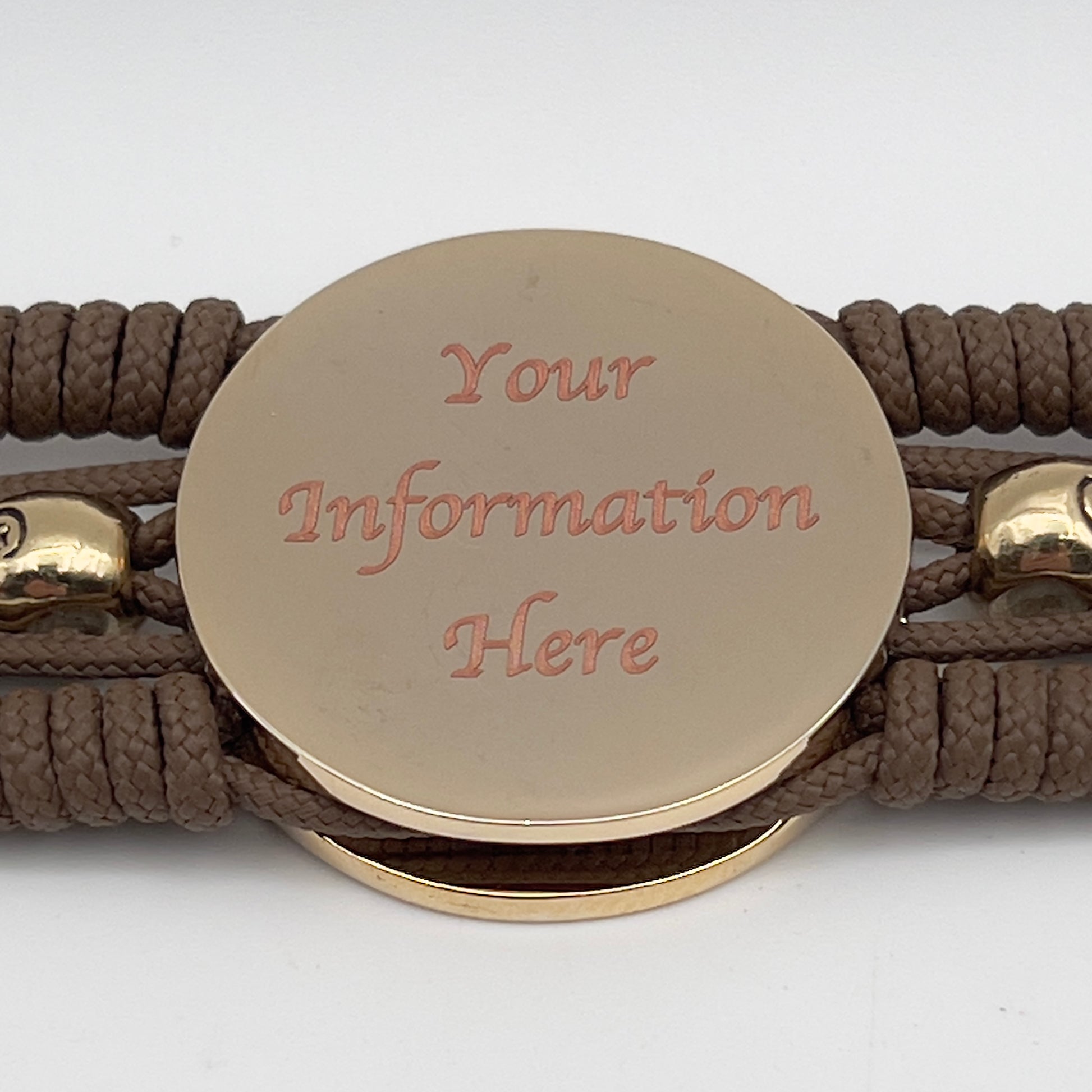 Thin, medium width, flexible and comfortable braided United States Marine Corps bracelet featuring a 24K gold and silver plated USMC officer Eagle Globe and Anchor medallion, two gold micro skulls, a gold Cobra style tactical buckle and woven with Coyote Brown type-1 paracord.