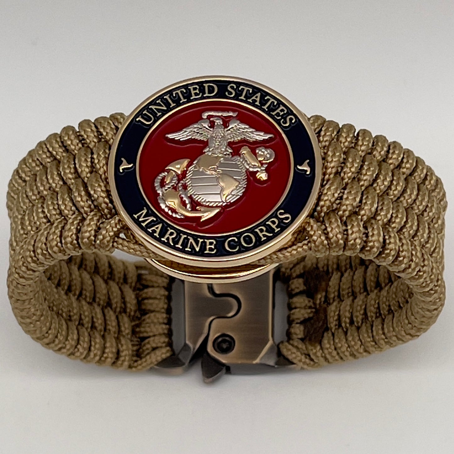 Thin, wide, flexible and comfortable braided United States Marine Corps bracelet featuring a 24K gold and silver plated USMC Eagle Globe and Anchor medallion, a gold Cobra style tactical buckle and woven with gold type-1 paracord.