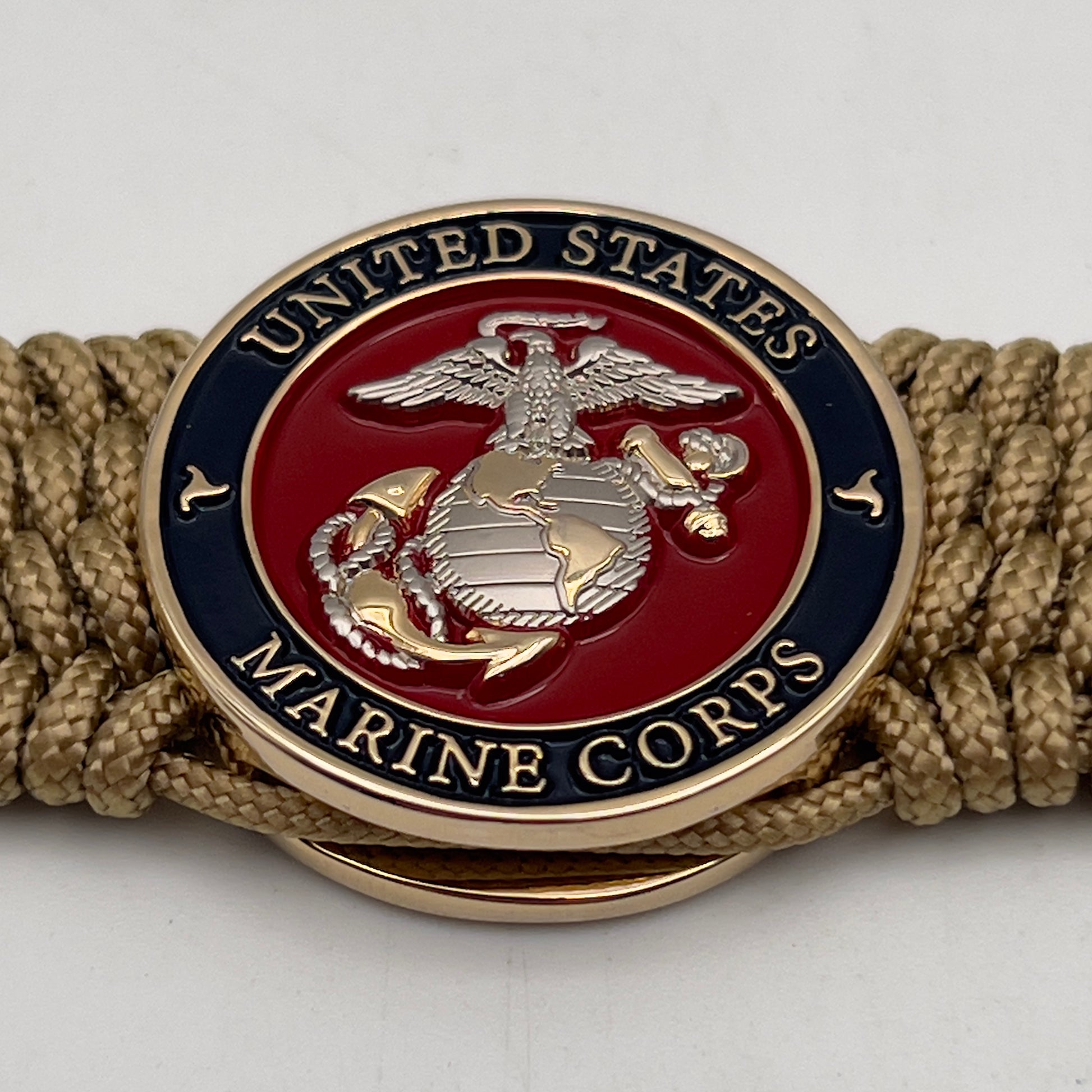 Thin, wide, flexible and comfortable braided United States Marine Corps bracelet featuring a 24K gold and silver plated USMC Eagle Globe and Anchor medallion, a gold Cobra style tactical buckle and woven with gold type-1 paracord.