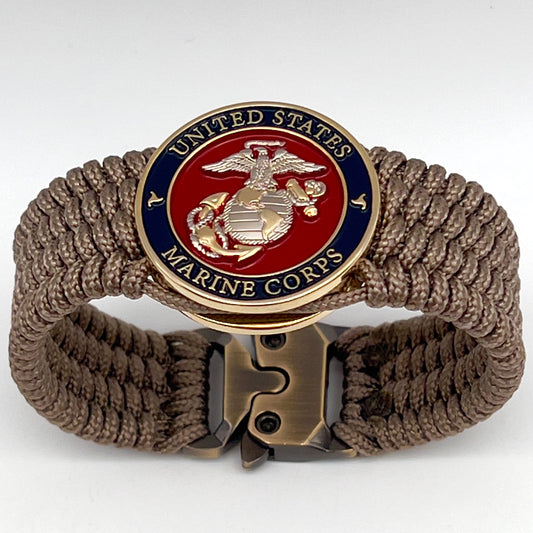 Thin, wide, flexible and comfortable braided United States Marine Corps bracelet featuring a 24K gold and silver plated USMC Eagle Globe and Anchor medallion, a gold Cobra style tactical buckle and woven with tan type-1 paracord.