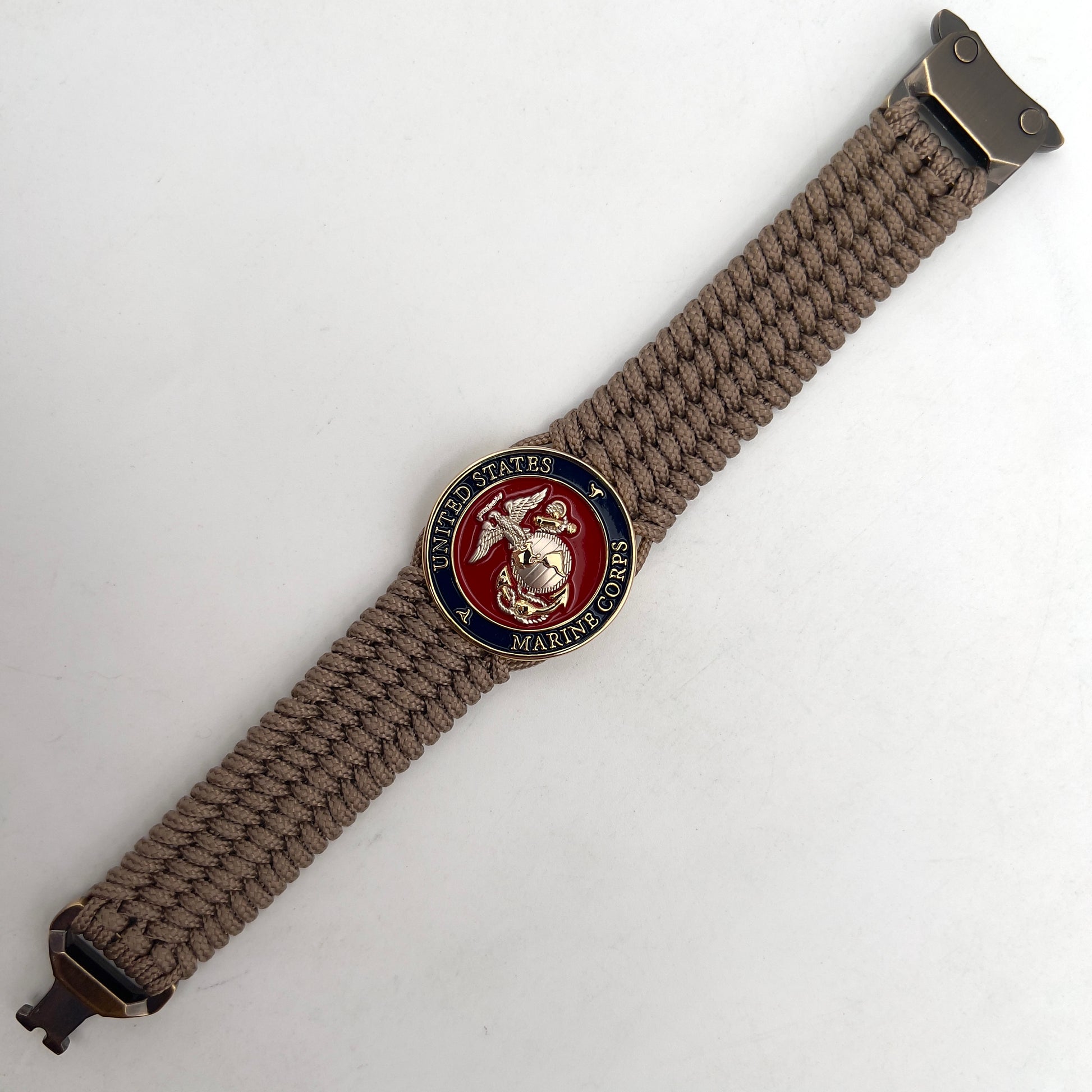 Thin, wide, flexible and comfortable braided United States Marine Corps bracelet featuring a 24K gold and silver plated USMC Eagle Globe and Anchor medallion, a gold Cobra style tactical buckle and woven with tan type-1 paracord.