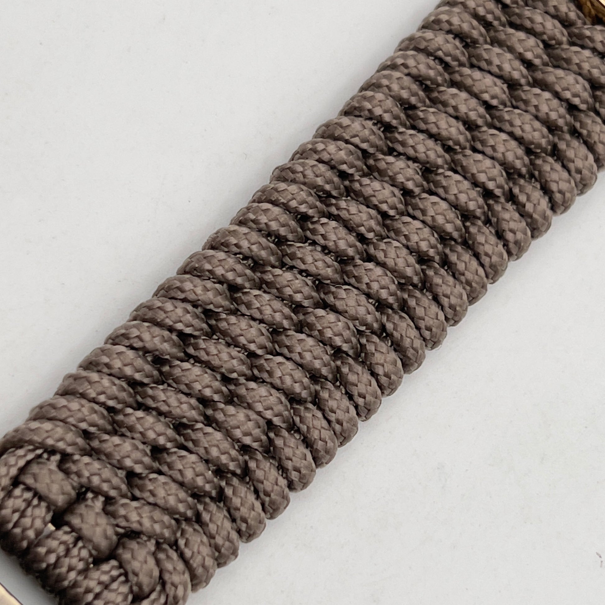 Thin, wide, flexible and comfortable braided United States Marine Corps bracelet featuring a 24K gold and silver plated USMC Eagle Globe and Anchor medallion, a gold Cobra style tactical buckle and woven with tan type-1 paracord.