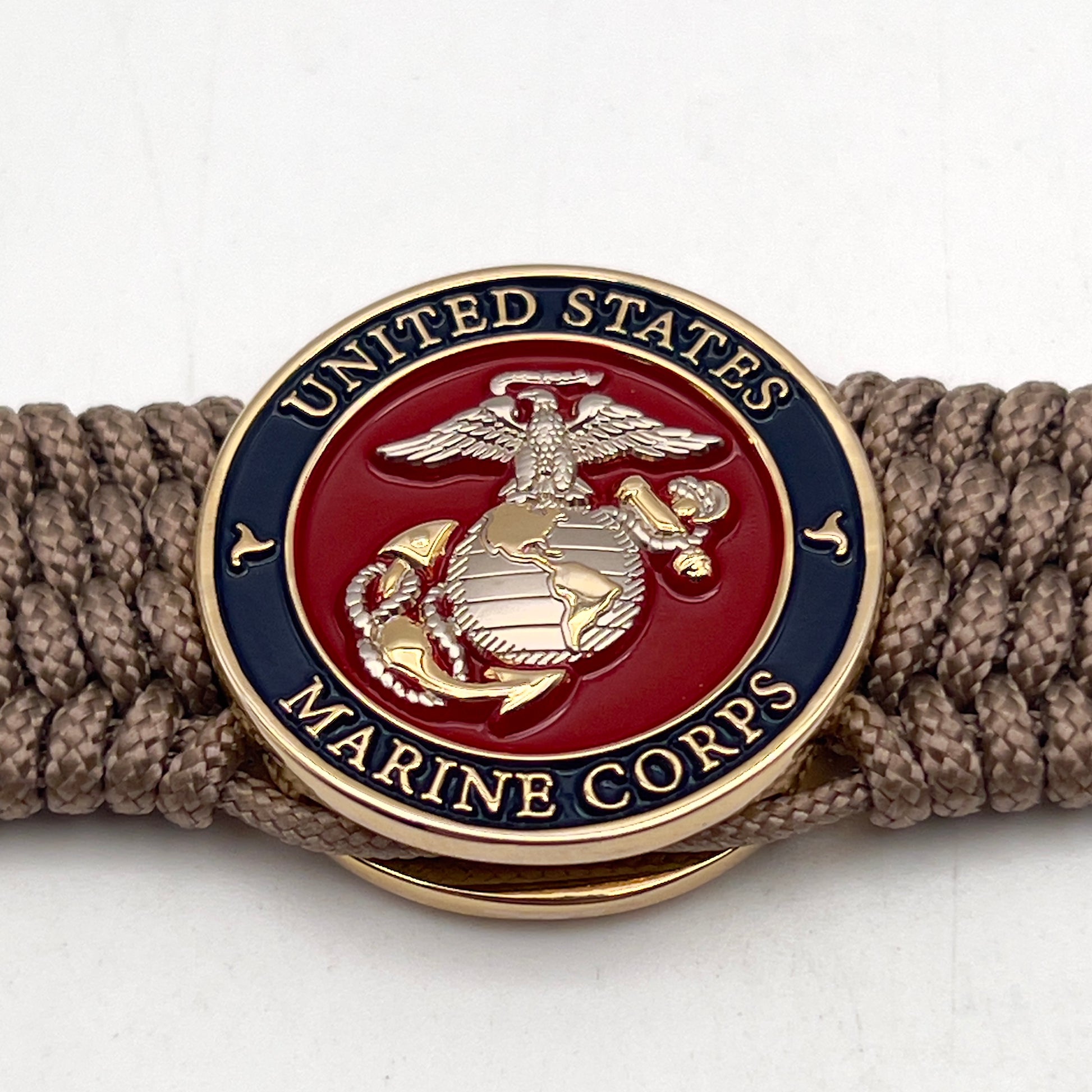 Thin, wide, flexible and comfortable braided United States Marine Corps bracelet featuring a 24K gold and silver plated USMC Eagle Globe and Anchor medallion, a gold Cobra style tactical buckle and woven with tan type-1 paracord.