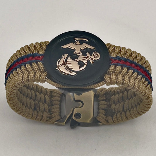 Thin, medium width, flexible and comfortable braided United States Marine Corps bracelet featuring a gold USMC Eagle Globe and Anchor medallion, a gold Cobra style tactical buckle and woven with gold Type-1 paracord and stitched with red and blue nano cord.