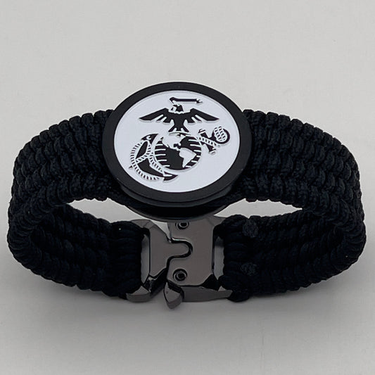 Thin, medium width, flexible and comfortable braided United States Marine Corps bracelet featuring a black USMC Eagle Globe and Anchor medallion, a black Cobra style tactical buckle and woven with black Type-1 paracord.
